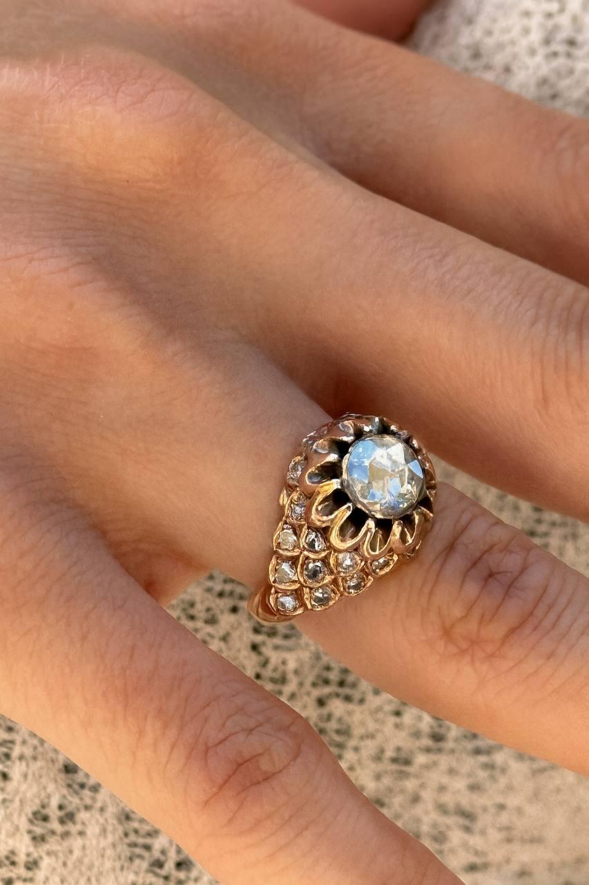 Elevate your collection with this exquisite rose-cut diamond ring, crafted in luxurious 14k gold. The design showcases a luminous central rose-cut diamond, framed in a scalloped floral-inspired bezel that radiates timeless elegance.

The band is