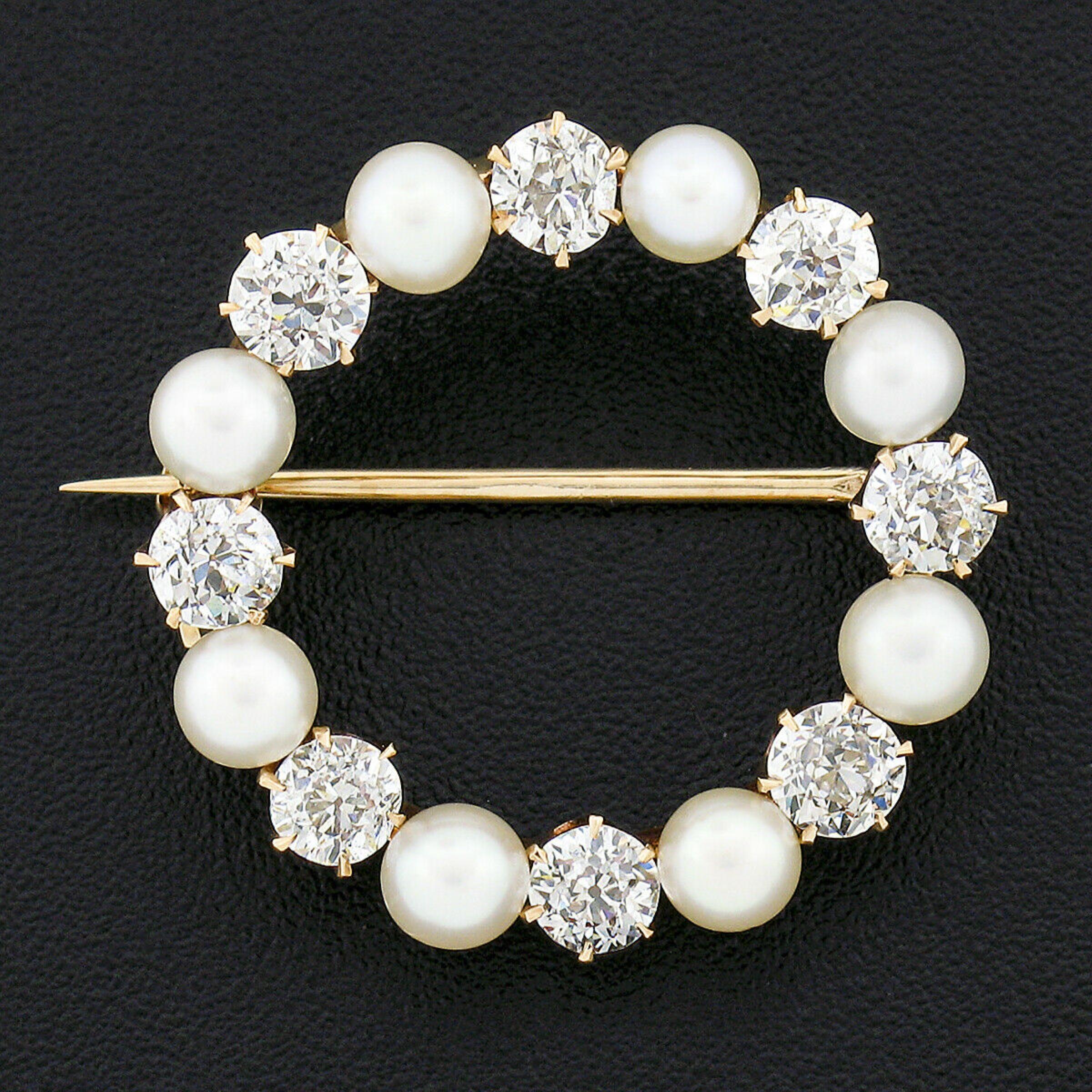This absolutely gorgeous antique brooch was crafted during the 1900's from solid 14k gold. It features an incredible circle of pearls and diamonds that alternate throughout its simple circular wreath design. The very high quality pearls are well