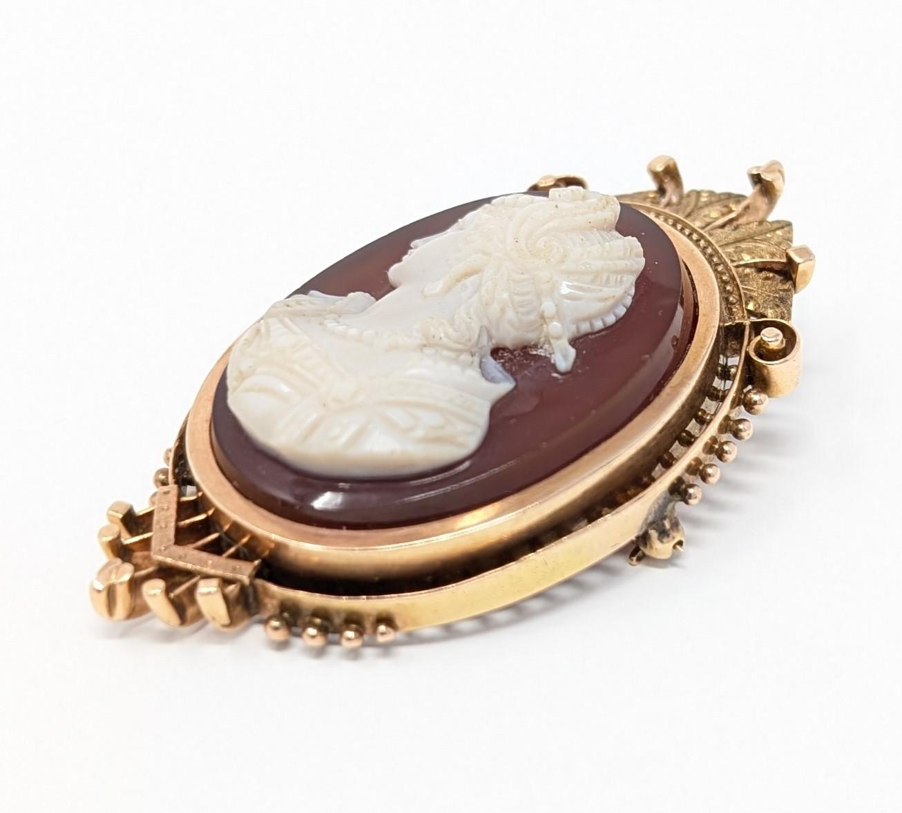 Stunning antique hand carved sardonyx cameo in 14k yellow gold, wonderful for collectors of finely crafted jewelry. This convertible piece can be worn either as a brooch or as a pendant and is unmarked to our knowledge (verified by our jeweler for