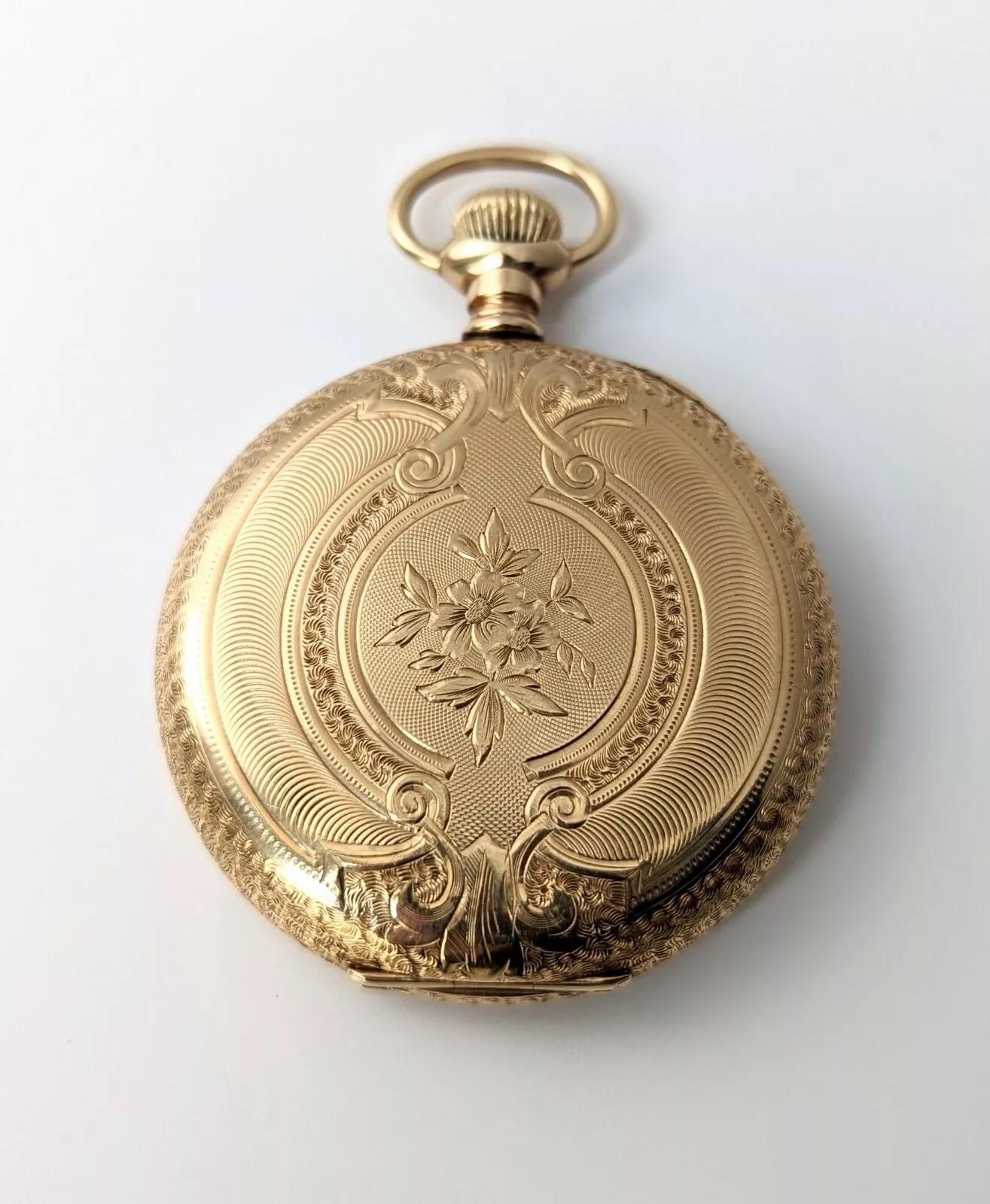 Beautifully crafted antique Waltham pocket watch in a stunning solid 14k yellow gold hunters case by Keystone. This pocket watch is circa late 1800's to early 1900's and features a monogram front with floral back, very ornately engraved. Hefty in