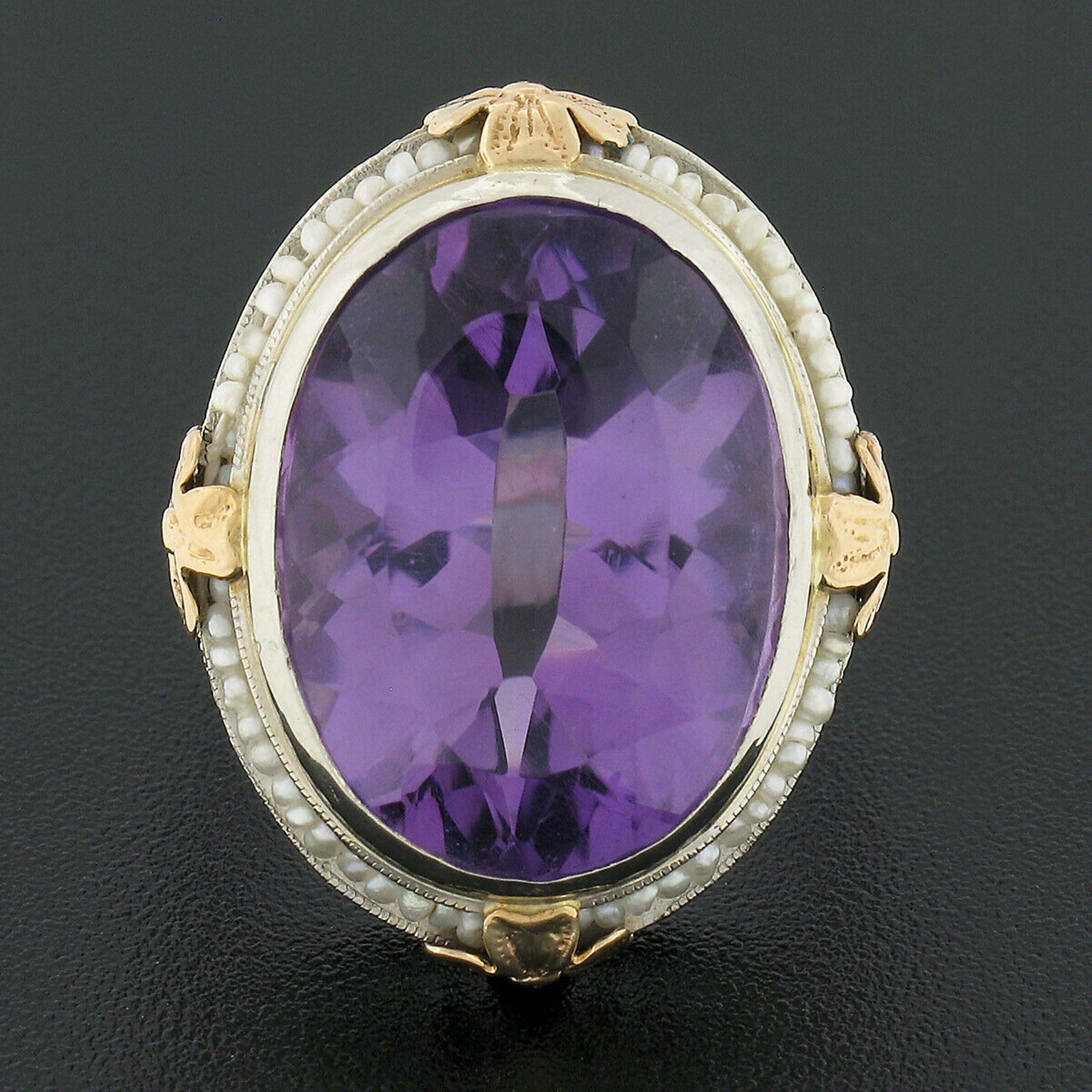 This magnificent antique ring is crafted in solid 14k white gold and features a large oval cut amethyst neatly bezel set at its center. The stone stands out with its gorgeous medium purple color and large size, weighing approximately 15 carats, and