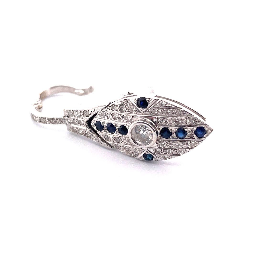 Captivate with our stunning 14K White Gold Sapphire and Diamond Eye Pendant/Pin, boasting a mesmerizing antique Victorian design. The eye-shaped piece features a central round white diamond, surrounded by six sapphires, three below and three above