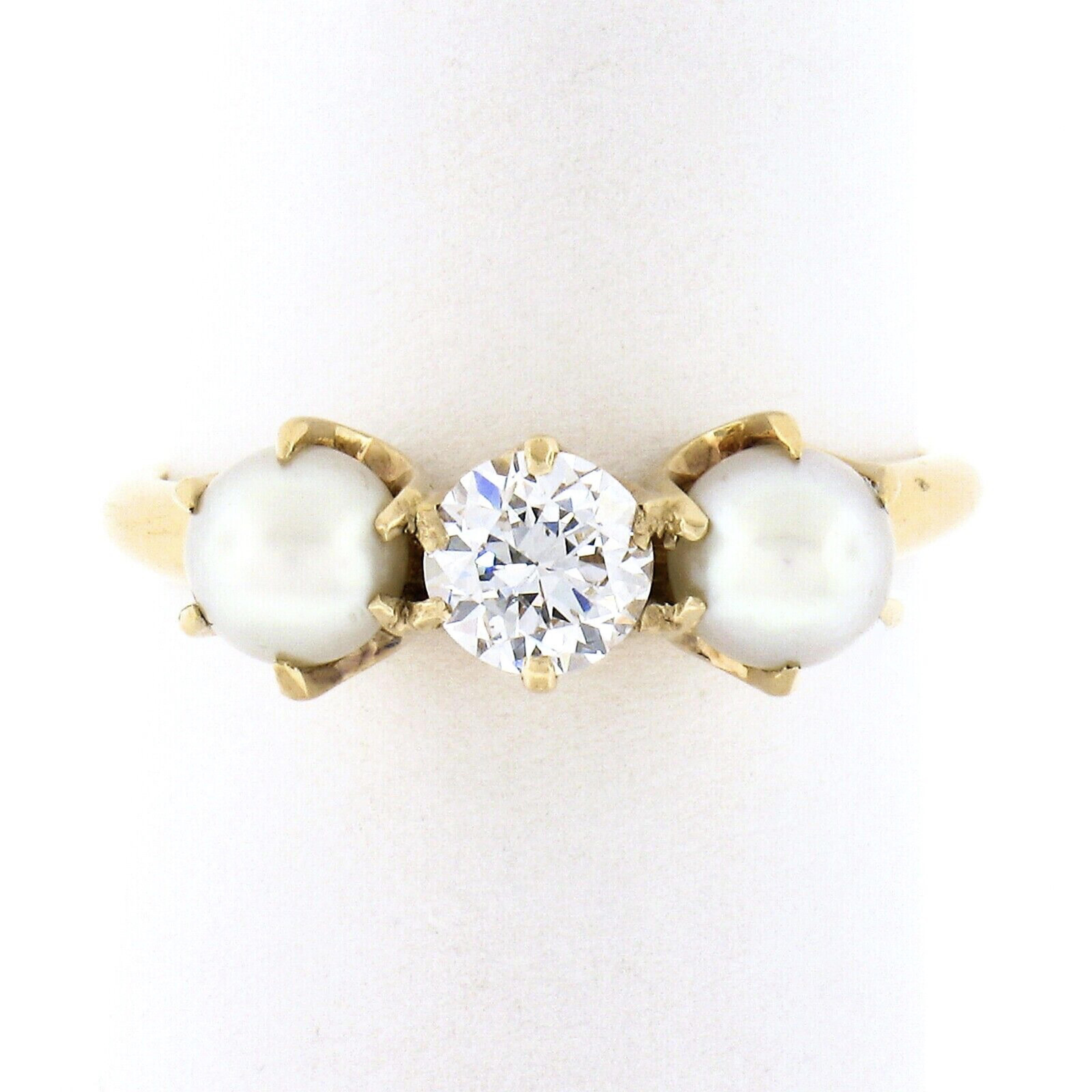 This simply gorgeous antique ring was crafted from solid 14k yellow gold and features a classic and absolutely stunning combination of diamond and pearls elegantly prong set across its top. The super fiery old European cut diamond solitaire sits at