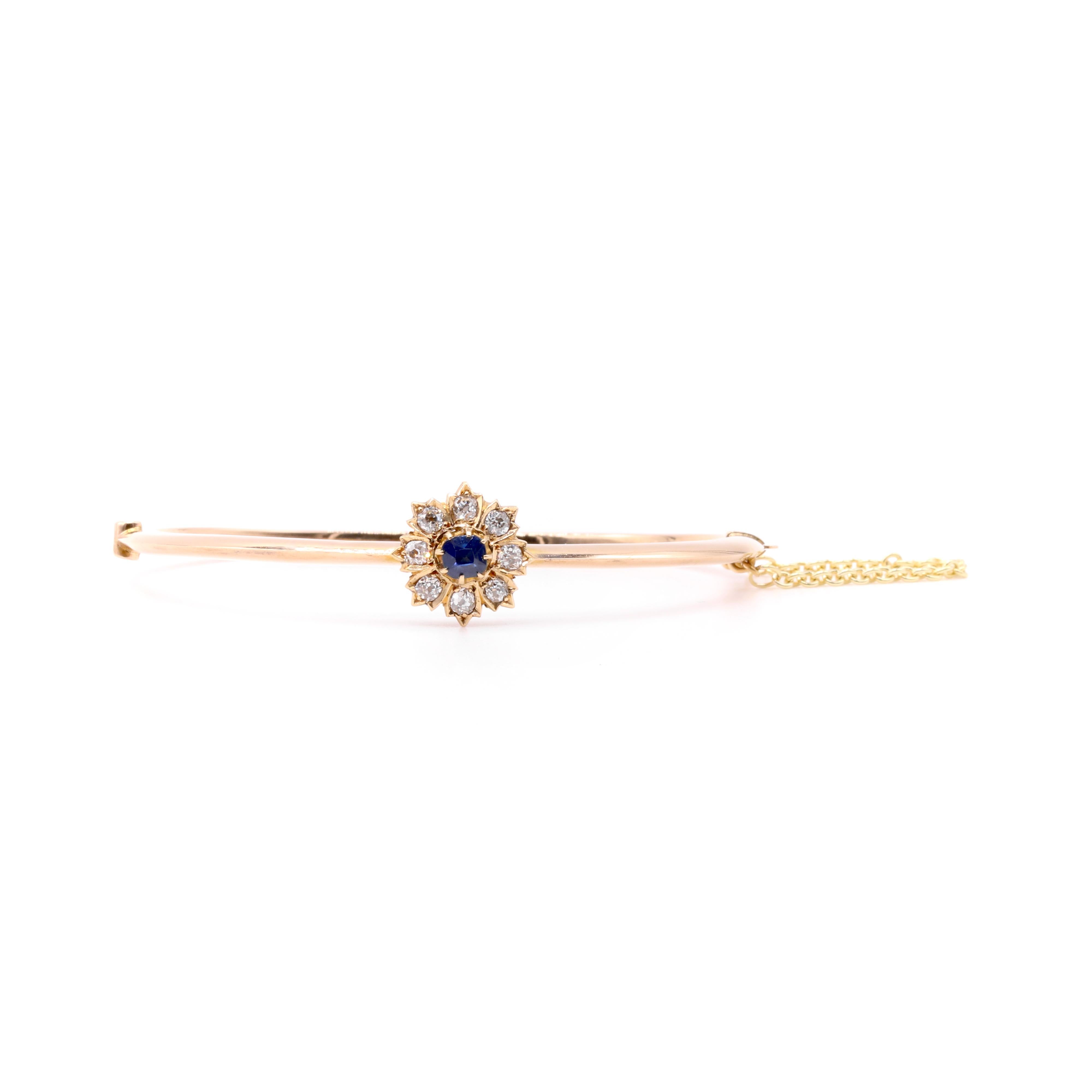 A Victorian sapphire, diamond, and yellow gold bangle, comprising one cushion shaped blue sapphire, and eight old mine cut diamonds, in 14 karat yellow gold. 

My favourite thing about this Victorian 14K Yellow Gold Sapphire and Diamond Bangle, is