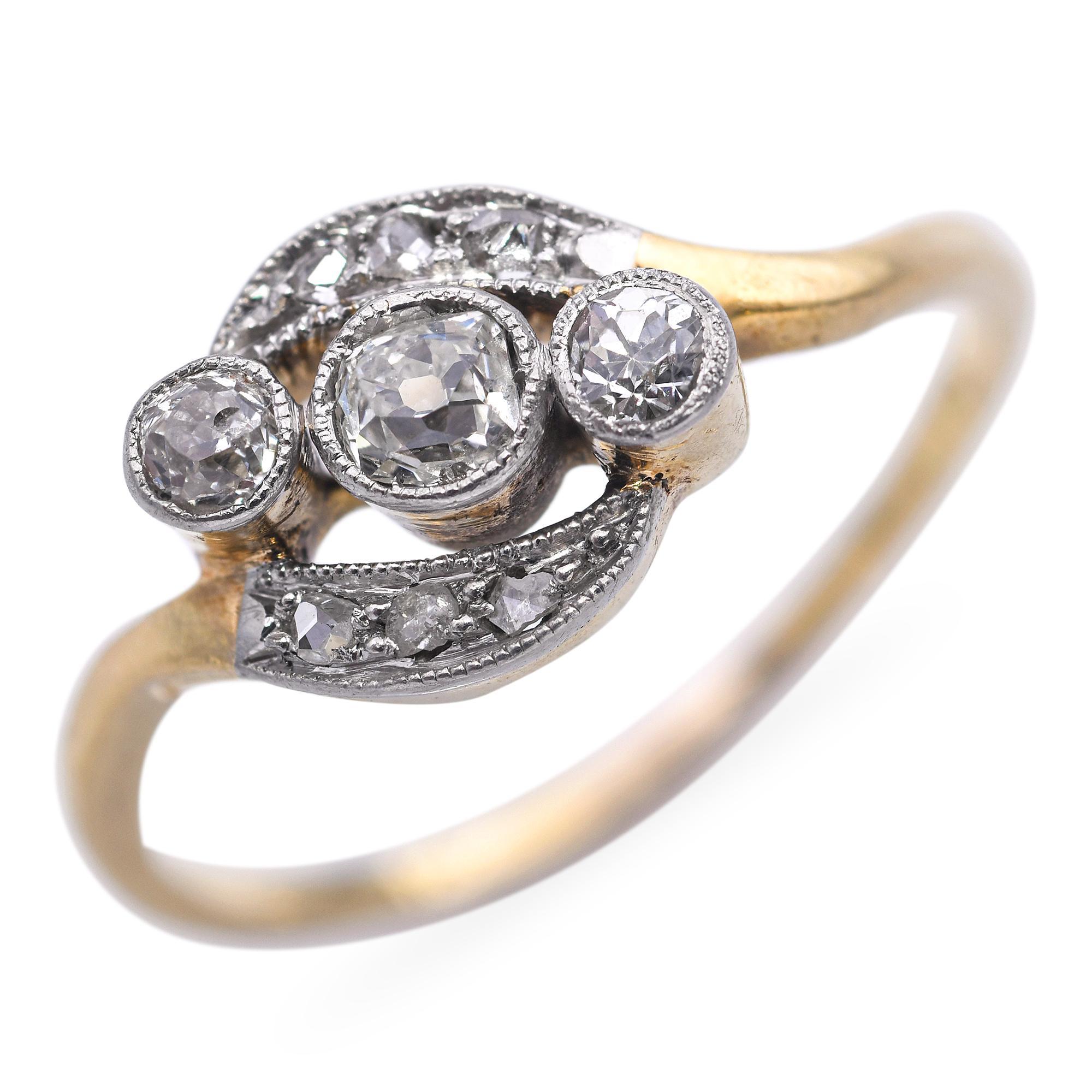 This charming antique ring is crafted in warm 14k yellow gold and showcases approximately 0.21 total carats of old cut diamonds. The diamonds are set in a delicate vintage-style arrangement that highlights their subtle sparkle and antique charm.