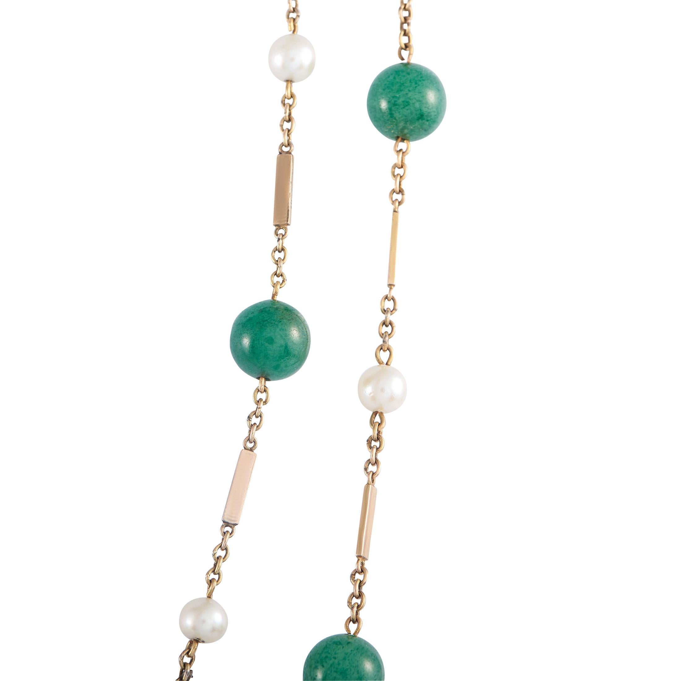 An antique long necklace that gracefully nods to East Asian artistry through its design of alternating lustrous pearls and smooth jade beads. The green and white combination is spread along a 60-inch-long chain in 14K yellow gold. This piece weighs