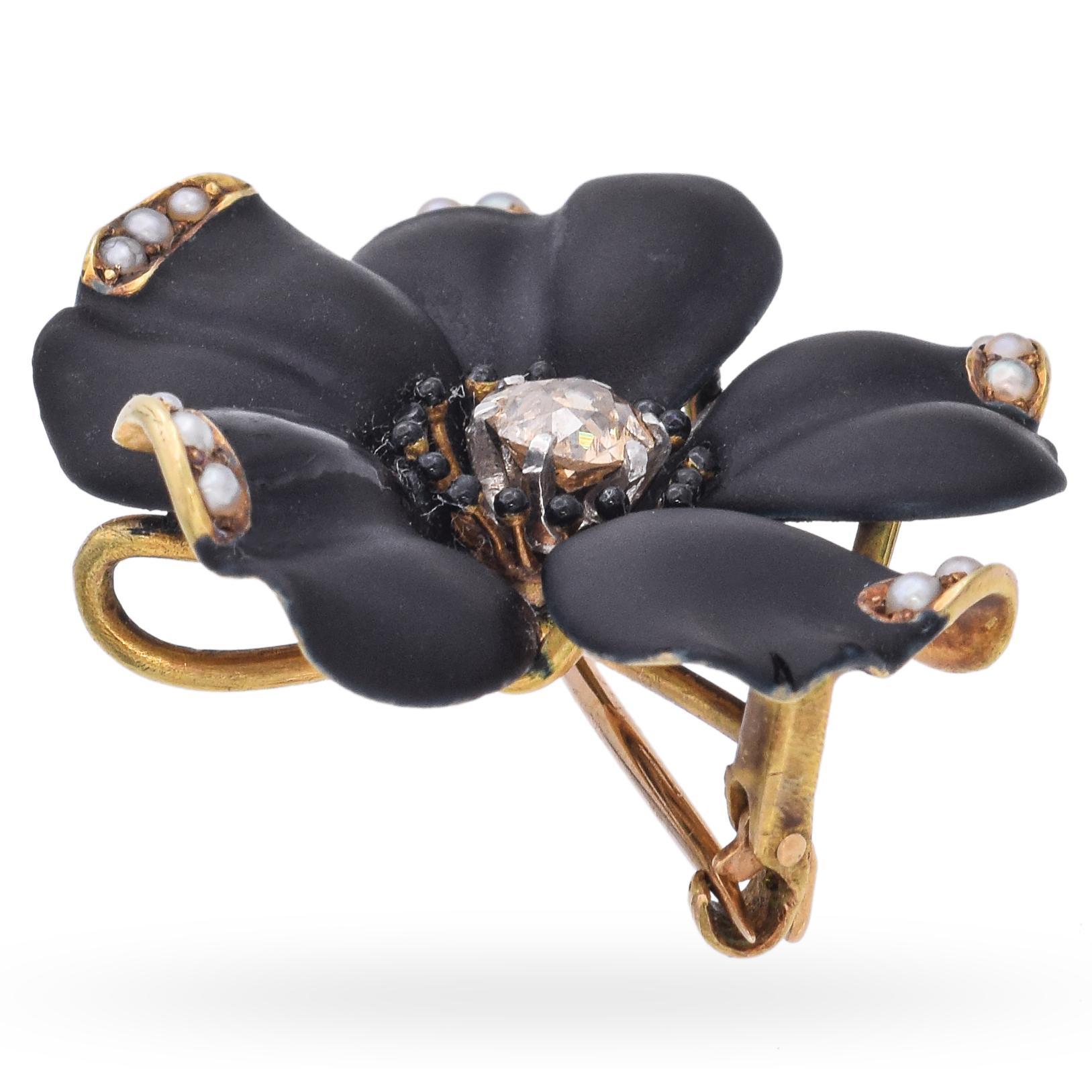 This exquisite brooch features a striking black flower design. The petals are adorned with small pearls set in gold accents at their tips. At the center, an old European cut diamond is surrounded by black enamel and seed pearls.

Weight: 9.4