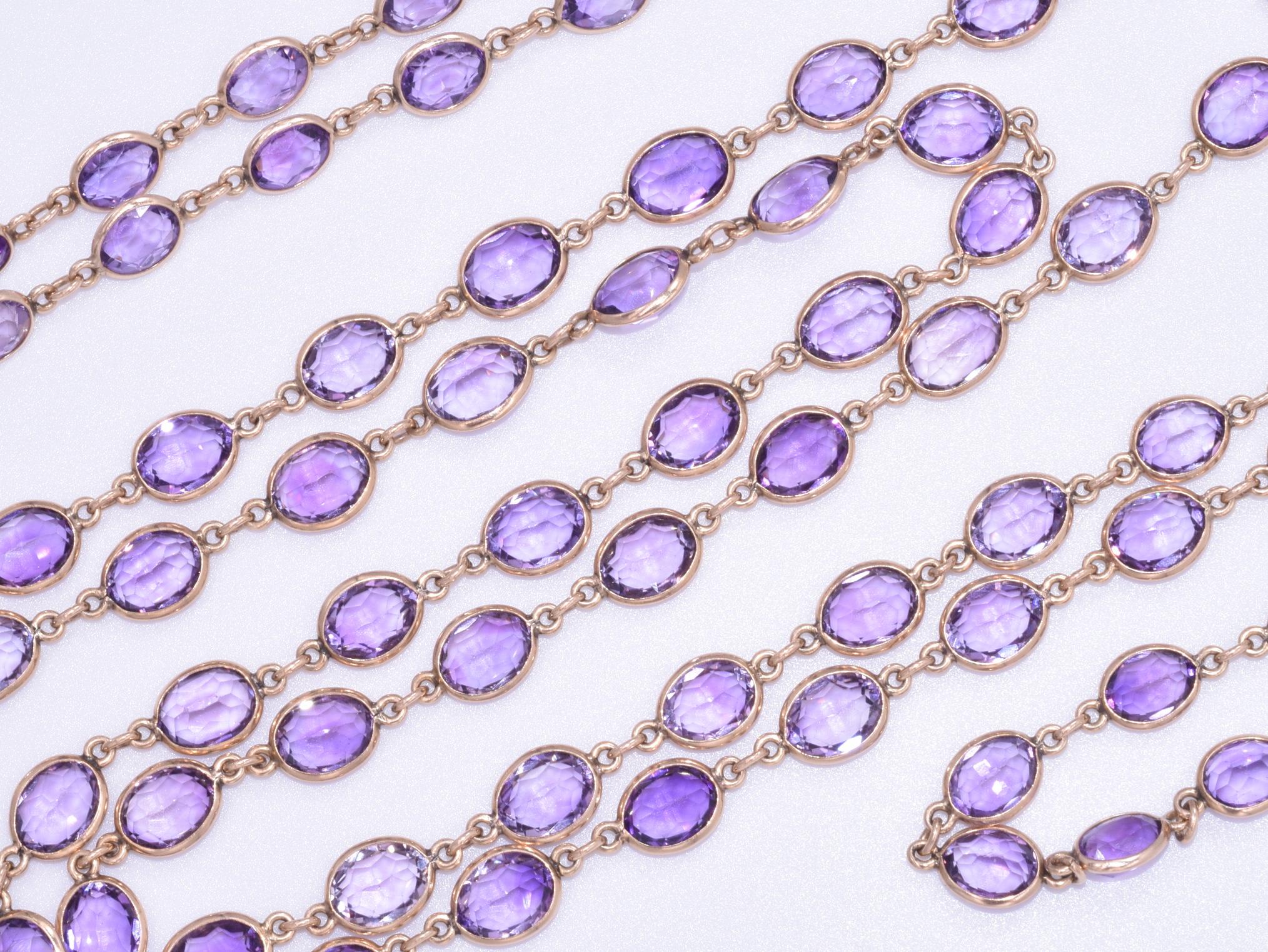 This antique yellow gold oval amethyst chain features, ninety-nine oval amethysts totaling approximately 100 carats are mounted in 14 karat yellow gold eyeglass bezels measuring 60 inches in length. Antique cut oval amethysts measure an average of