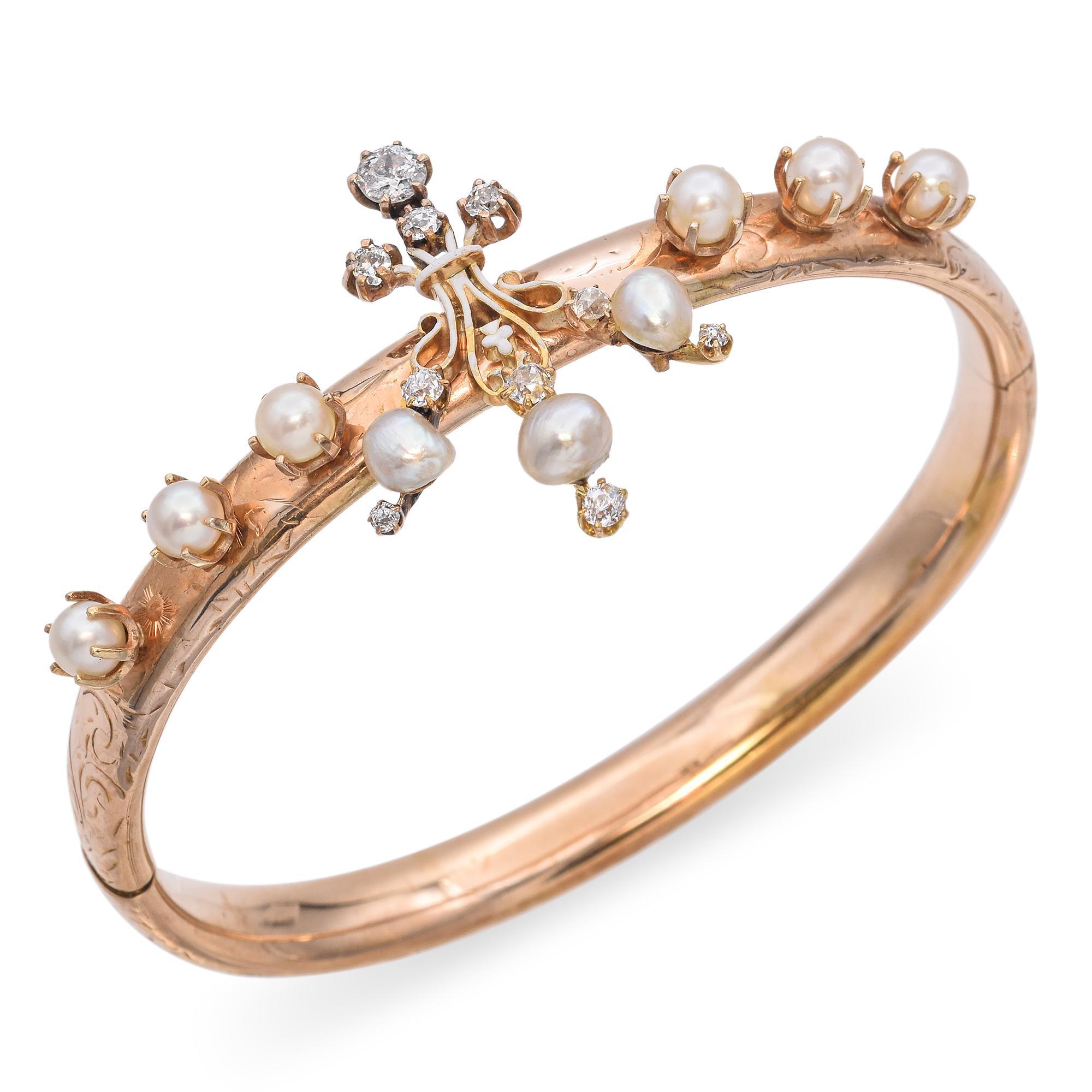 Antique pearl and diamond bangle bracelet.
This elegant bracelet is crafted in warm gold. The bracelet features a series of lustrous pearls set along the band, each held in a secure prong setting.
At the center, a decorative motif is adorned with