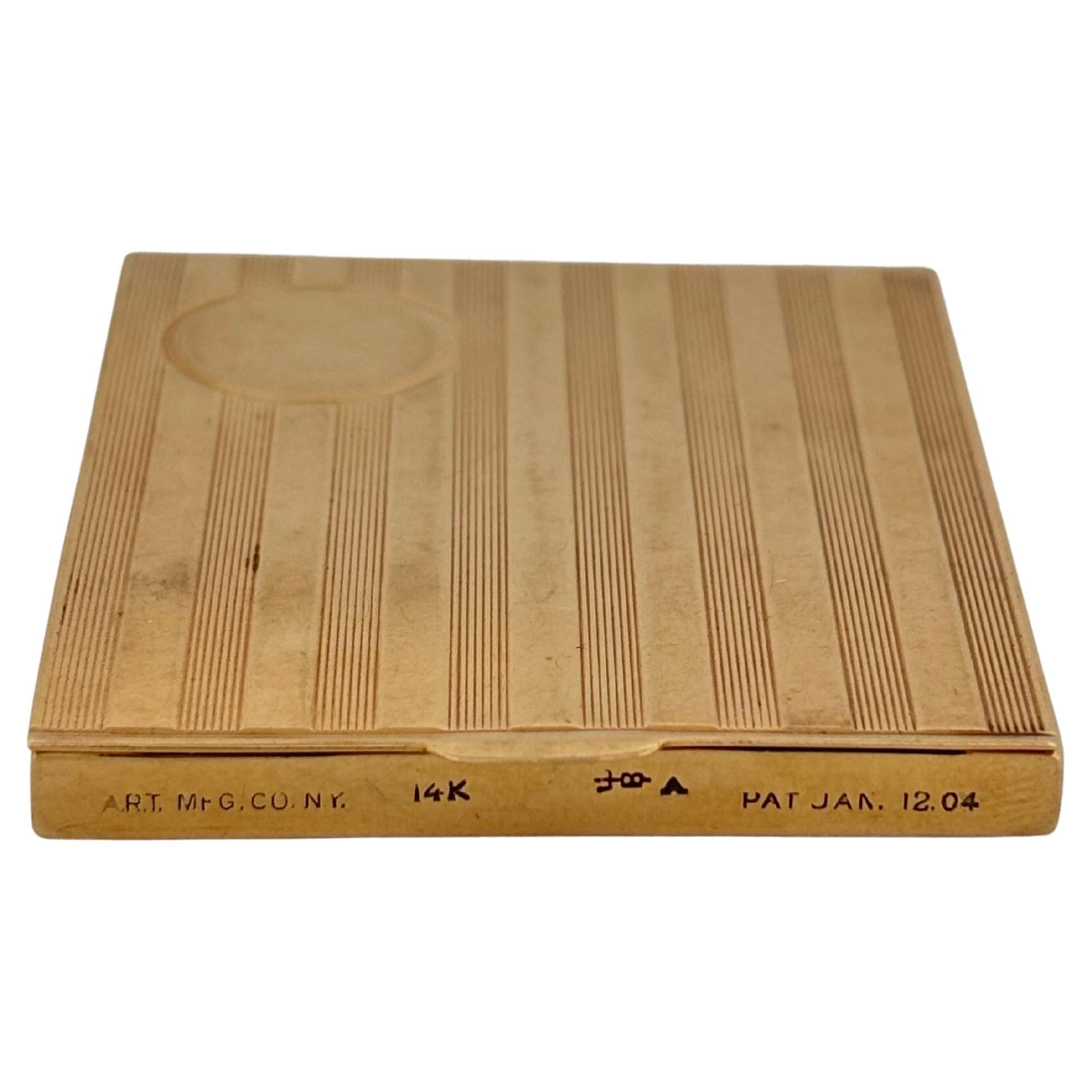 This elegant vintage match safe is expertly crafted from solid 14k yellow gold, showcasing timeless sophistication and fine craftsmanship. The exterior features a refined engine-turned striped pattern with a circular cartouche, perfect for a