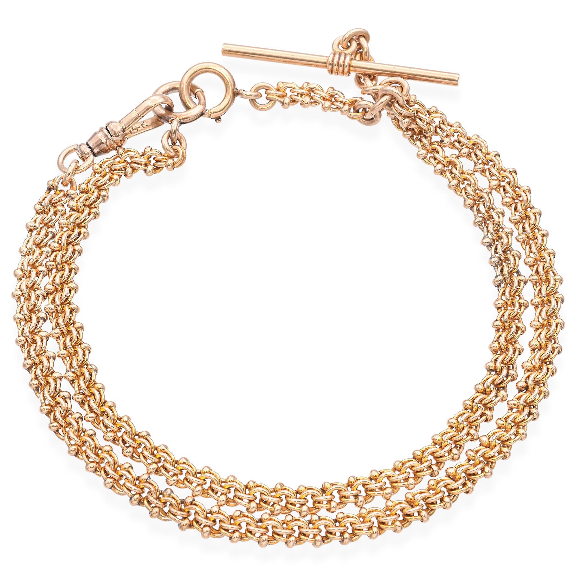Cette exquise chaîne de montre à gousset ancienne est fabriquée en or jaune 14 carats et présente un magnifique motif de maillons tressés. Dotée d'une barre en T classique et d'un solide fermoir à anneau à ressort, cette chaîne dégage une