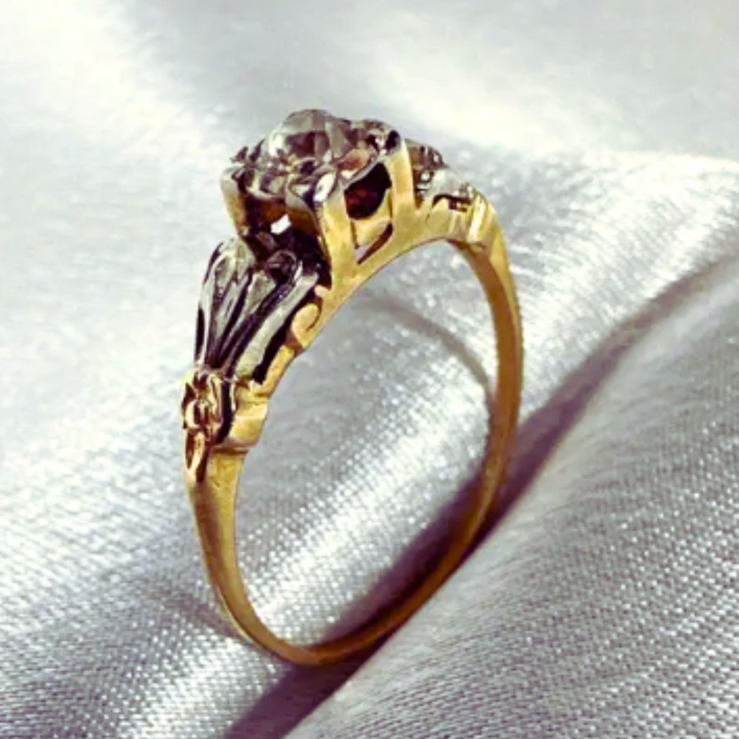 Step into a world of timeless allure with this captivating Antique 14K Yellow Gold Ring, artfully adorned with White Gold accents that add a touch of refinement to its classic design. The centerpiece of this vintage masterpiece is a stunning