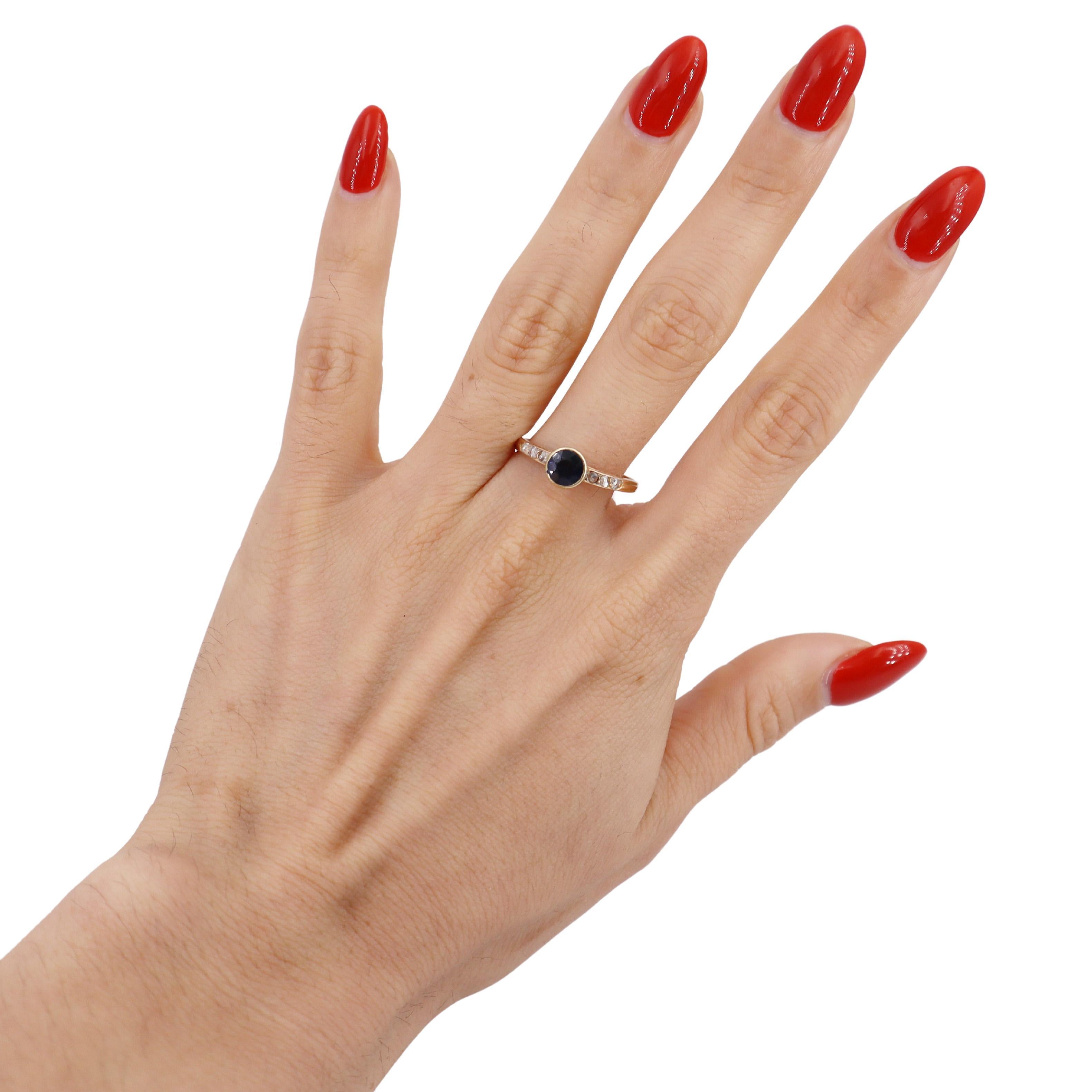 This beautiful Edwardian-era filigree ring, dating back to the 1910s, is a stunning representation of the elegance and craftsmanship of its time. Expertly crafted in 14kt yellow gold, this ring showcases a mesmerizing round cut blue sapphire at its