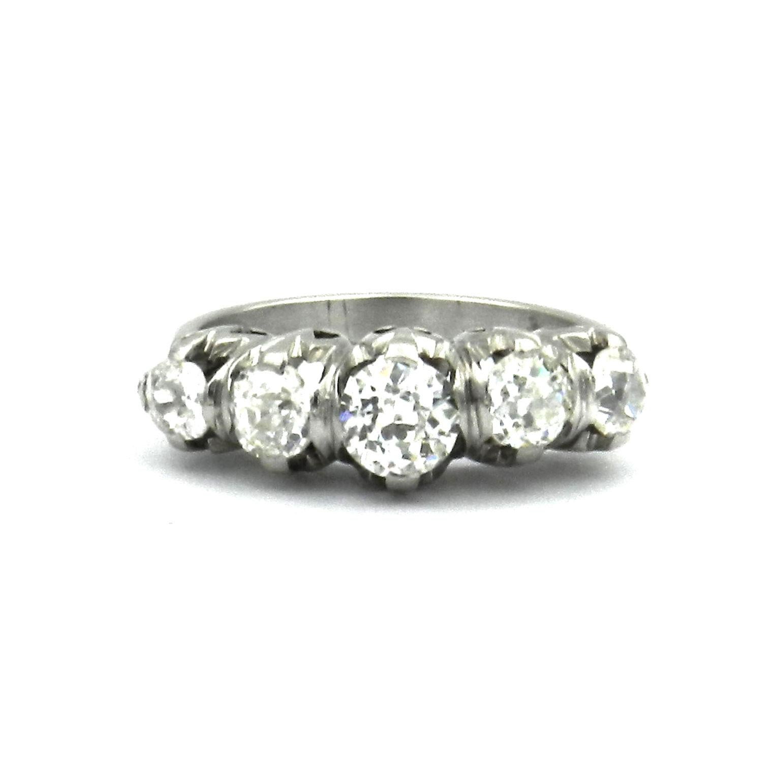 Antique 1.5 ct Diamond Five Stone Platinum Ring circa 1910

This distinctive antique five-stone diamond ring is crafted from platinum. It dates from the Edwardian period and was made around 1910. The center of the ring band is set with a large