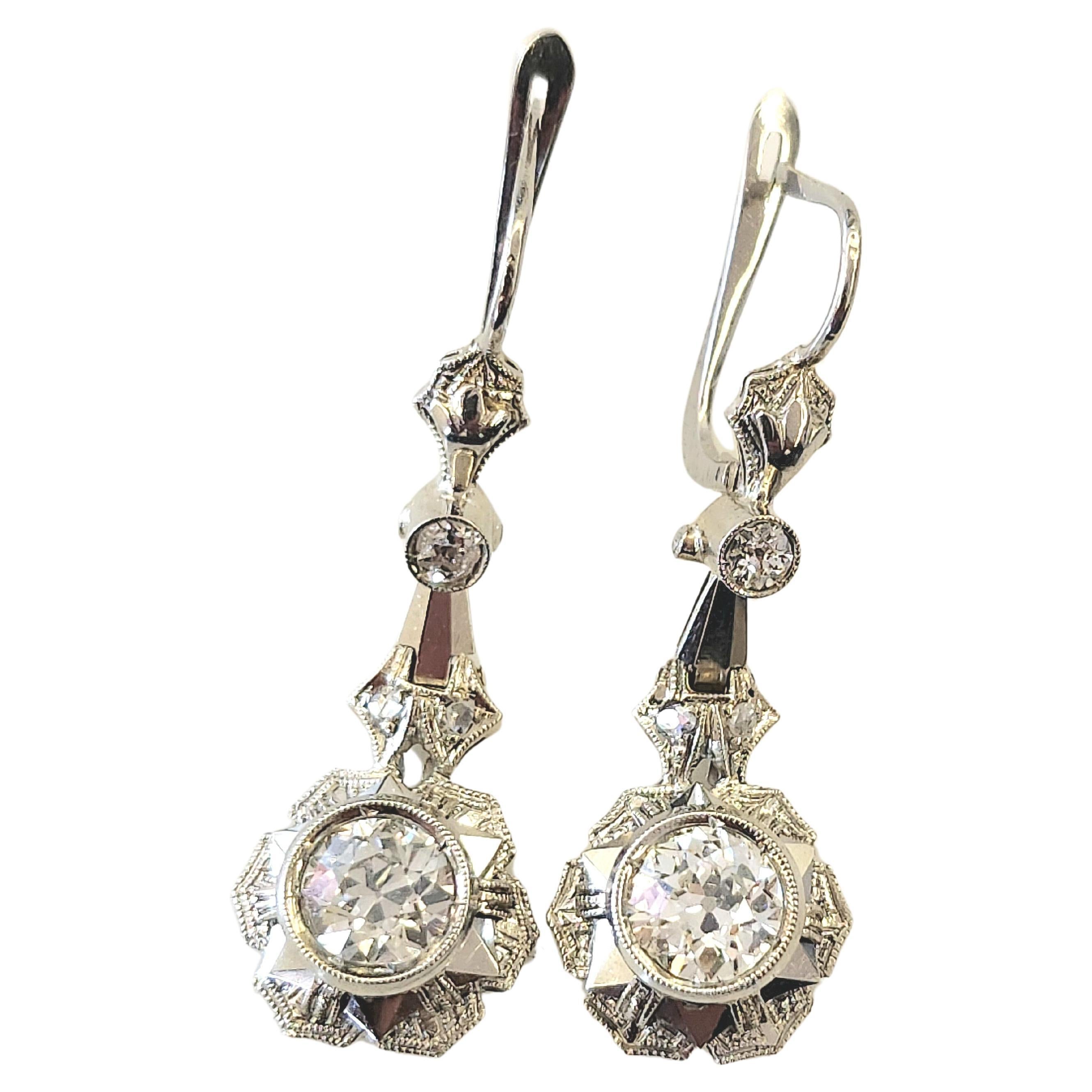 Art Deco era 1920s earrings made of 18k white gold centered with 2 old cut diamonds with a total weight of 1.50 carats 0.75ct each diamond weight H color white vvs clearity topped with 2 smaller diamonds in detailed art deco designe workmanship