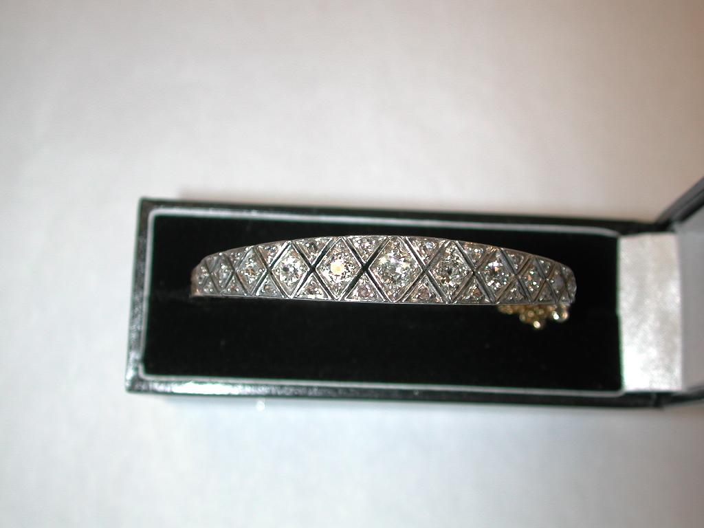 Antique 15ct Gold & Diamond Studded Bangle Dated Circa 1900
This superb quality bangle has a lovely graduated  centre row of 7 old mine cut  cushion shaped diamonds of a good colour.
The top is set in silver, to enhance the diamonds, diagonally hand