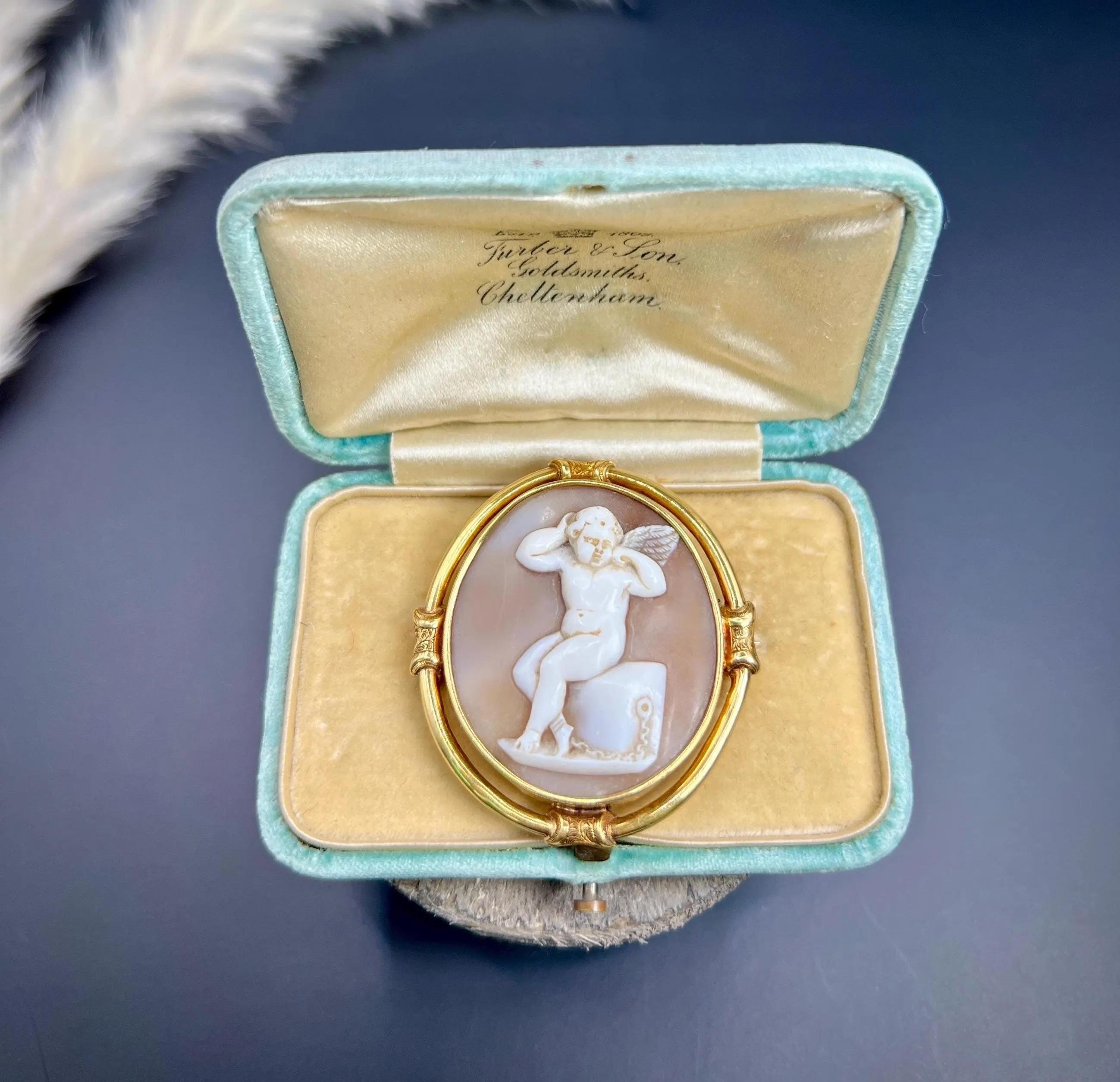 Antique Cameo Brooch

15ct Gold Tested 

Circa 1860 

This exquisite brooch showcases a charming cherub intricately carved from shell, encased in a stunning 15ct yellow gold frame. This piece beautifully captures the artistry and craftsmanship of