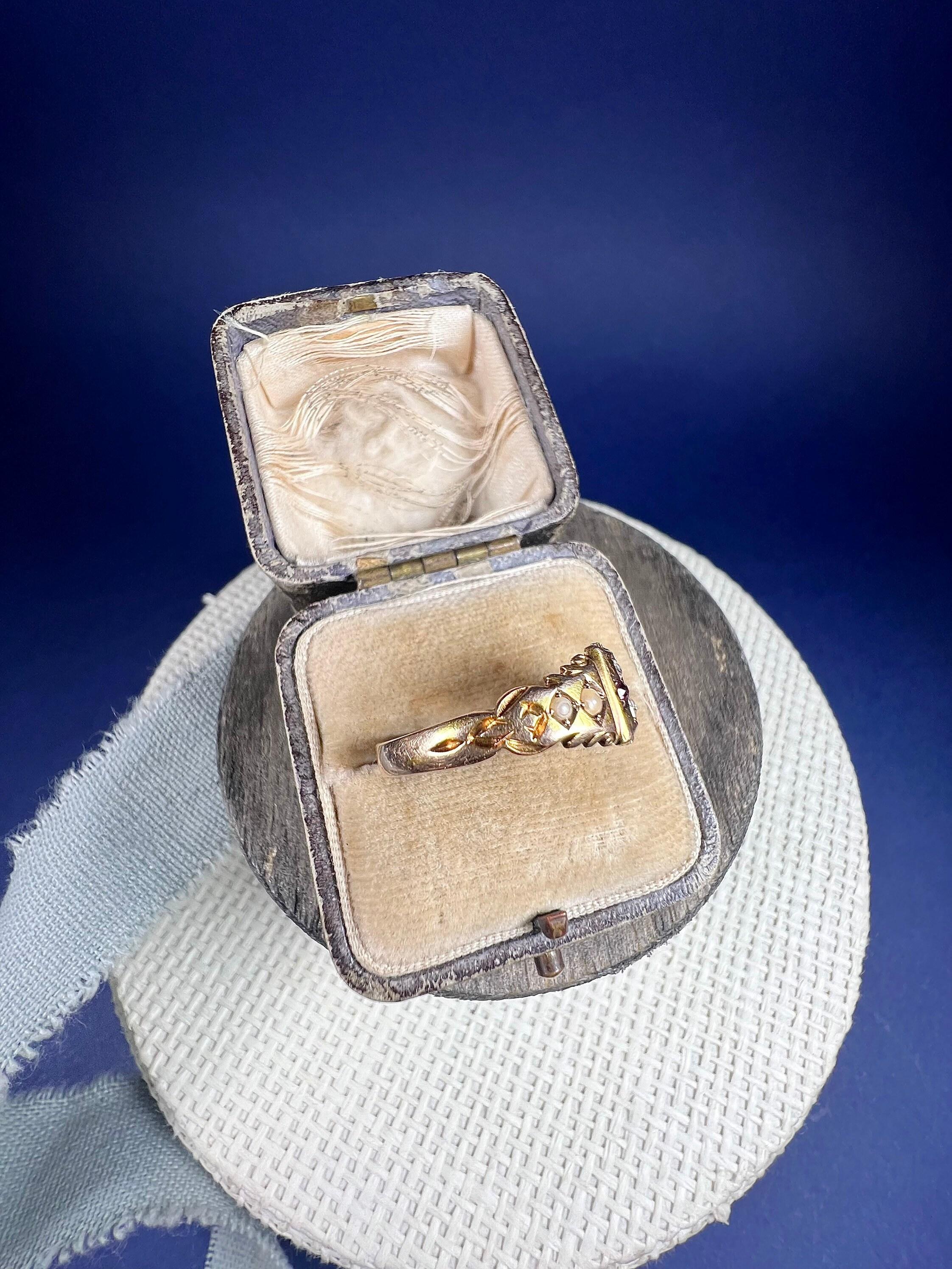 Antique 15ct Gold Ring 

15ct Gold 

Hallmarked Birmingham 1904

Beautiful, Edwardian gypsy ring. Set with a natural ruby & diamond cross centre with pretty, hand carved shoulders set with natural seed pearls. 

Ring height measures approximately