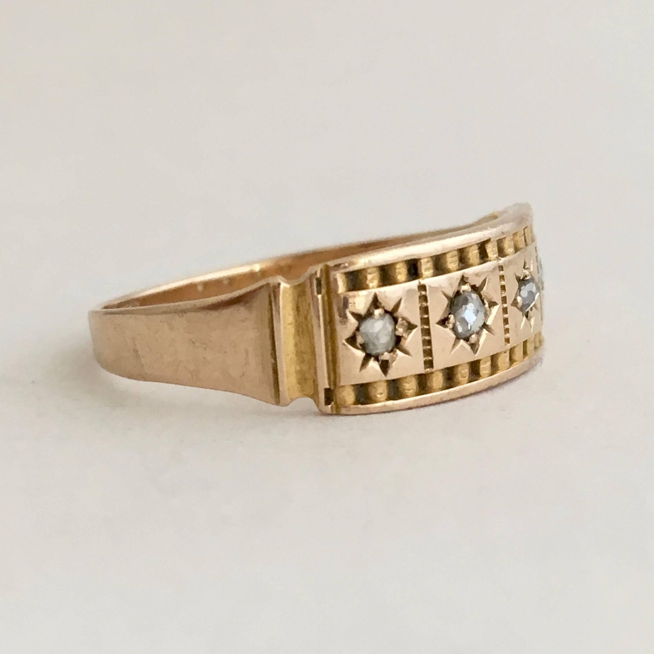 This stylish Victorian ring has a pleasingly contemporary look and feel with its tiny gypsy set diamonds and simple Etruscan revival detailing. The versatile 15ct gold band design looks chic worn alone but could also be stacked with other rings, or