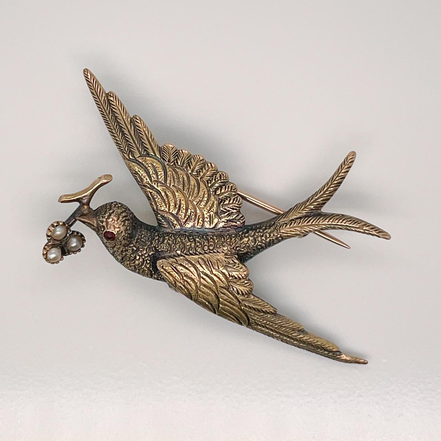 A very fine antique Victorian 15ct gold and seed pearl bird brooch. 

Modeled as a split-tail swallow with holding a branch in its mouth.  

Three seed pearls are prong set on end of the branch.  

Simply a wonderful antique brooch!

Date:
Early