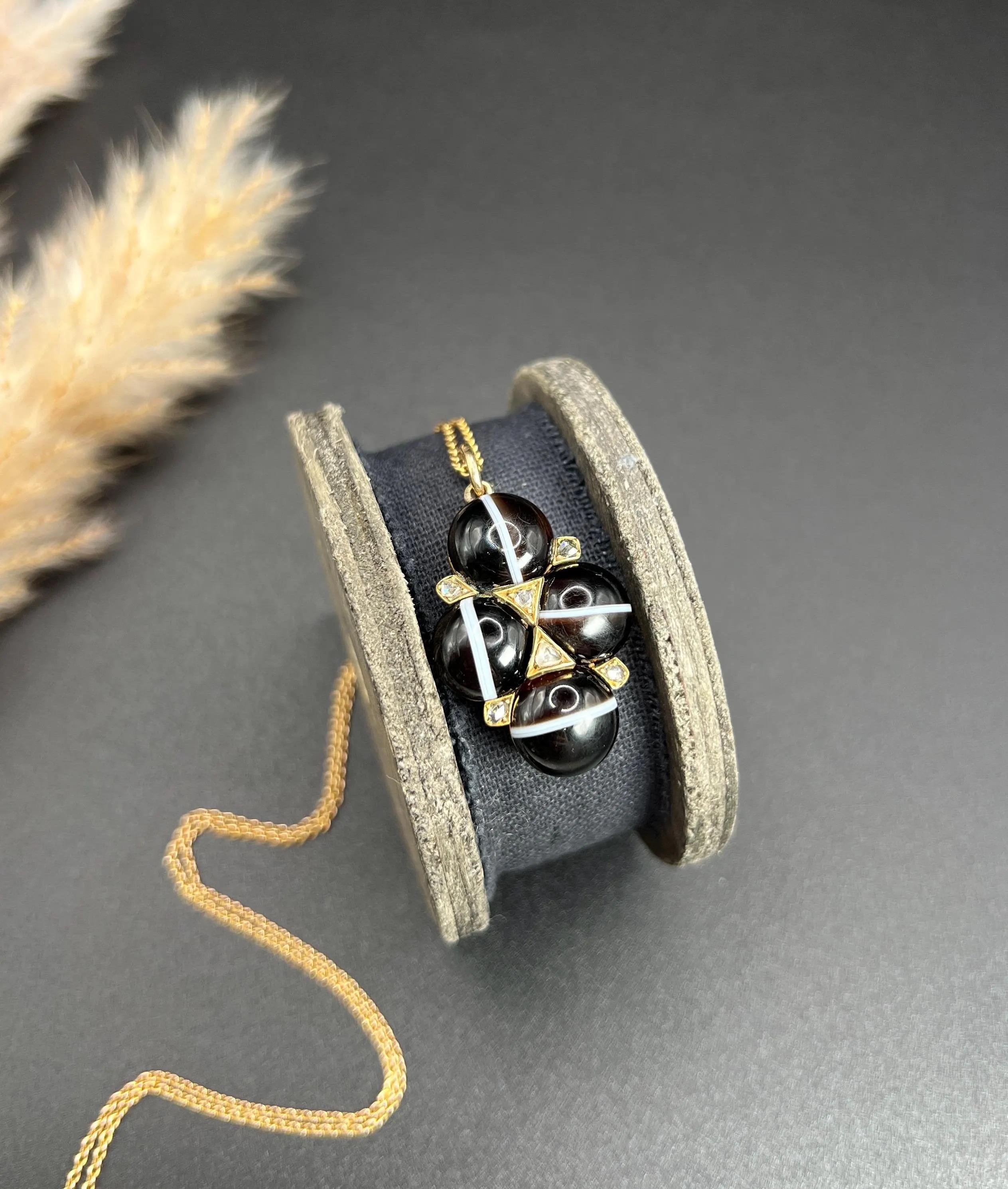 Antique Banded Agate Pendant 

15ct Gold

Circa 1870

* THE CHAIN IS SOLD SEPARATELY 

Introducing a stunning Victorian-era pendant crafted from 15ct yellow gold, showcasing a magnificent cross-shaped design. This exquisite piece features four round