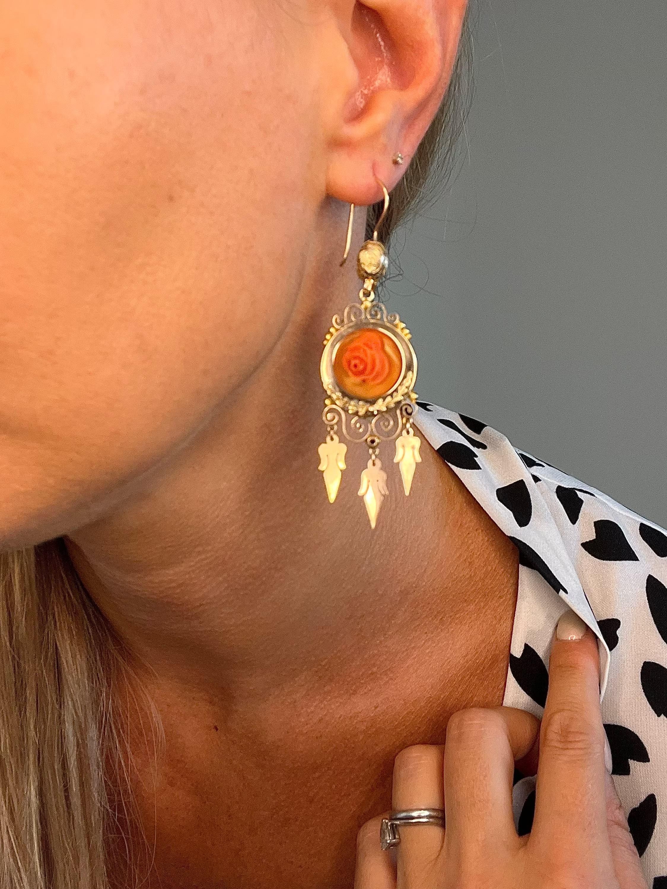 Antique Coral Earrings 

15ct Gold Tested 

Circa 1875

An Absolutely Stunning Pair of Fine Victorian Earrings. Set in Rose Gold, These Beautiful Drop Earrings Are Set with Fabulous, Hand Carved- Coral Rose Centre Pieces. 
Beautifully Decorated with