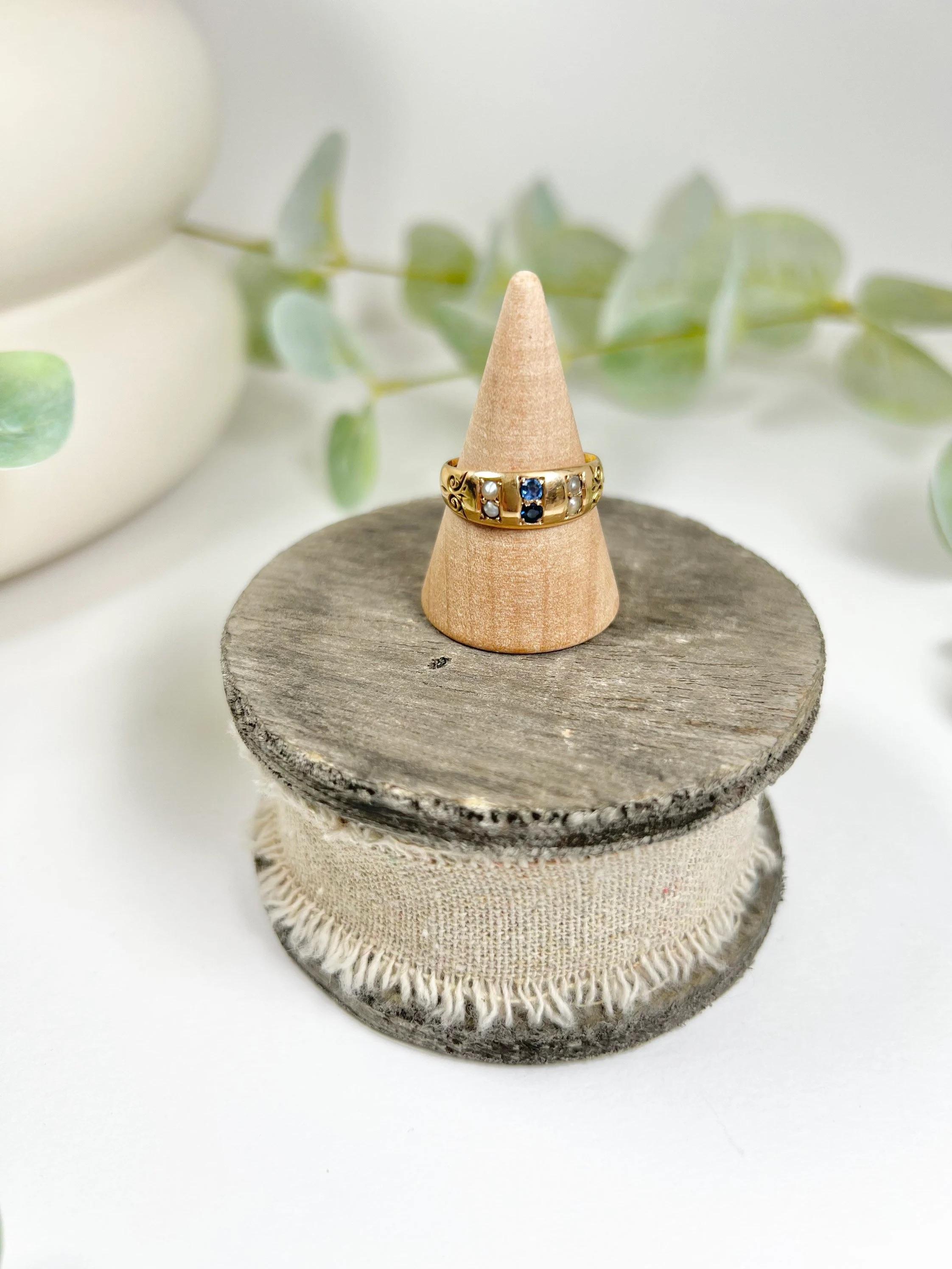 Antique Sapphire Ring 

15ct Gold Stamped 

Hallmarked Birmingham 1893

Beautiful, Edwardian ring. Set with gorgeous, natural sapphires & pretty seed pearls- set in to a lovely yellow gold band. The ring features pretty scrolled shoulders & a