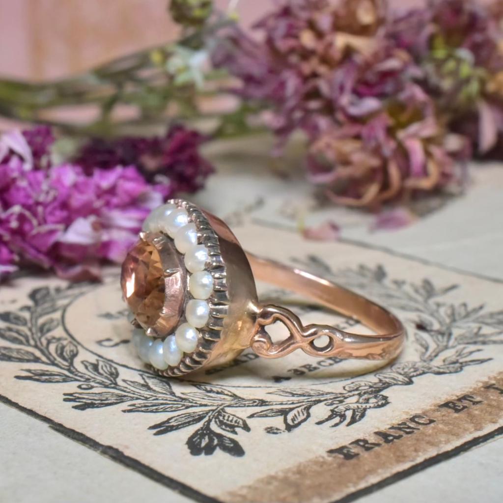 Dating to the Georgian to very early Victorian eras this wonderful ring is the epitome of antique elegance. 

Crafted from 15ct rose gold and centred with a large Imperial Topaz - approximately 2.30ct - which is a stunning peachy / orange in hue,