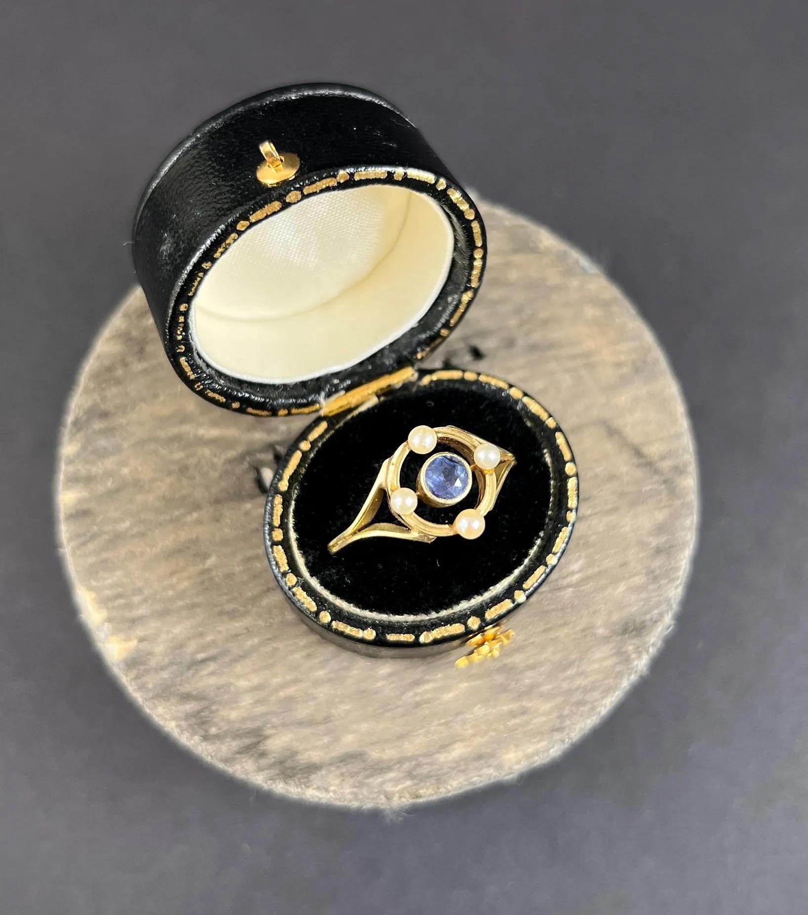 Antique Sapphire and Pearl Target Ring

15ct Gold Tested

Circa 1920s

Introducing a stunning 15ct yellow gold Art Nouveau ring with a target-style setting. The centre features a mesmerising faceted sapphire encircled by a delicate gold frame,
