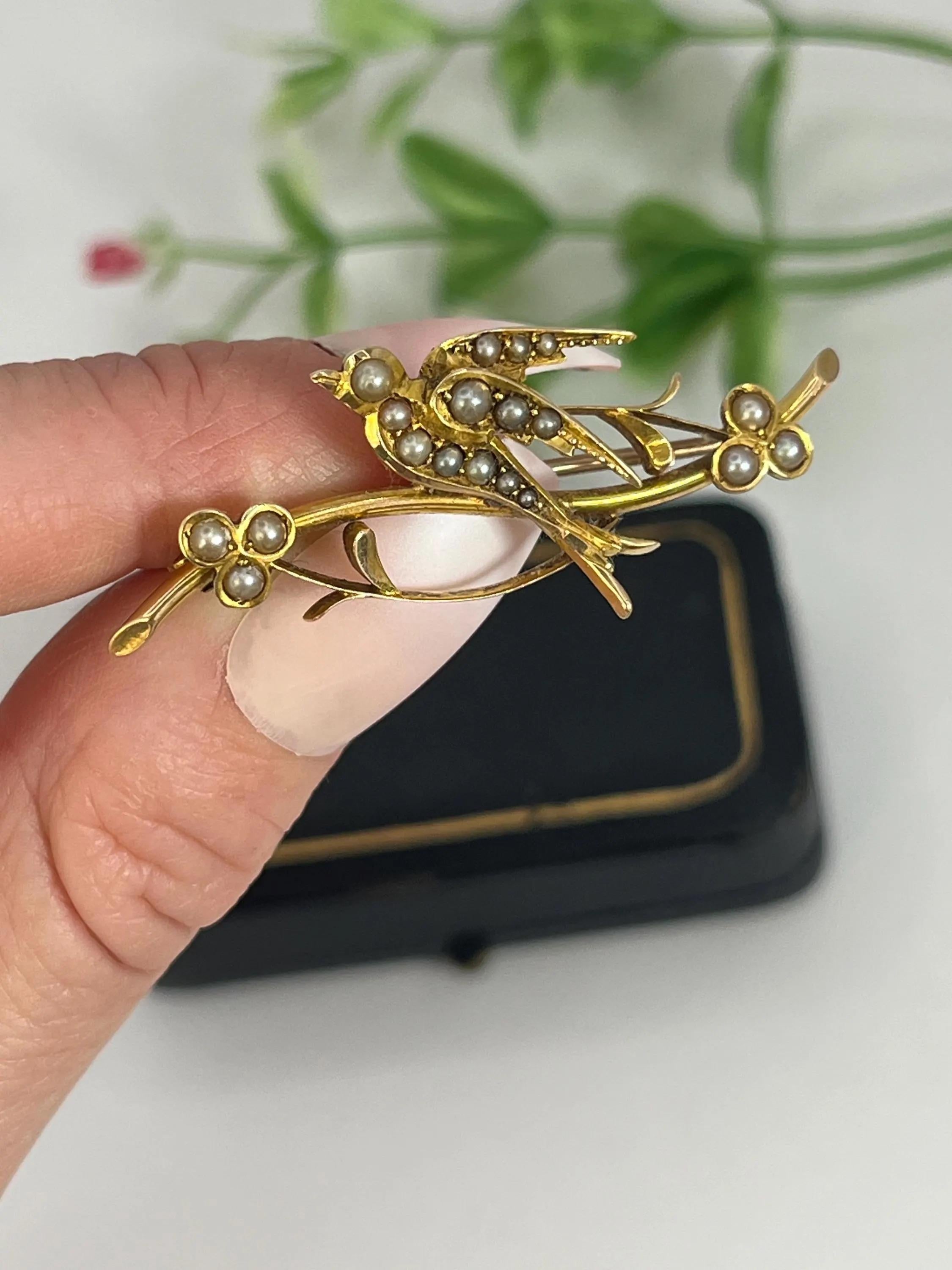 Antique Pearl Set Bird Brooch

15ct Gold Stamped

Circa 1900

A charming late Victorian brooch in 15ct yellow gold, modelled as a swallow perched serenely on a flowering branch. The bird’s form is gently contoured, with wings folded close and tail