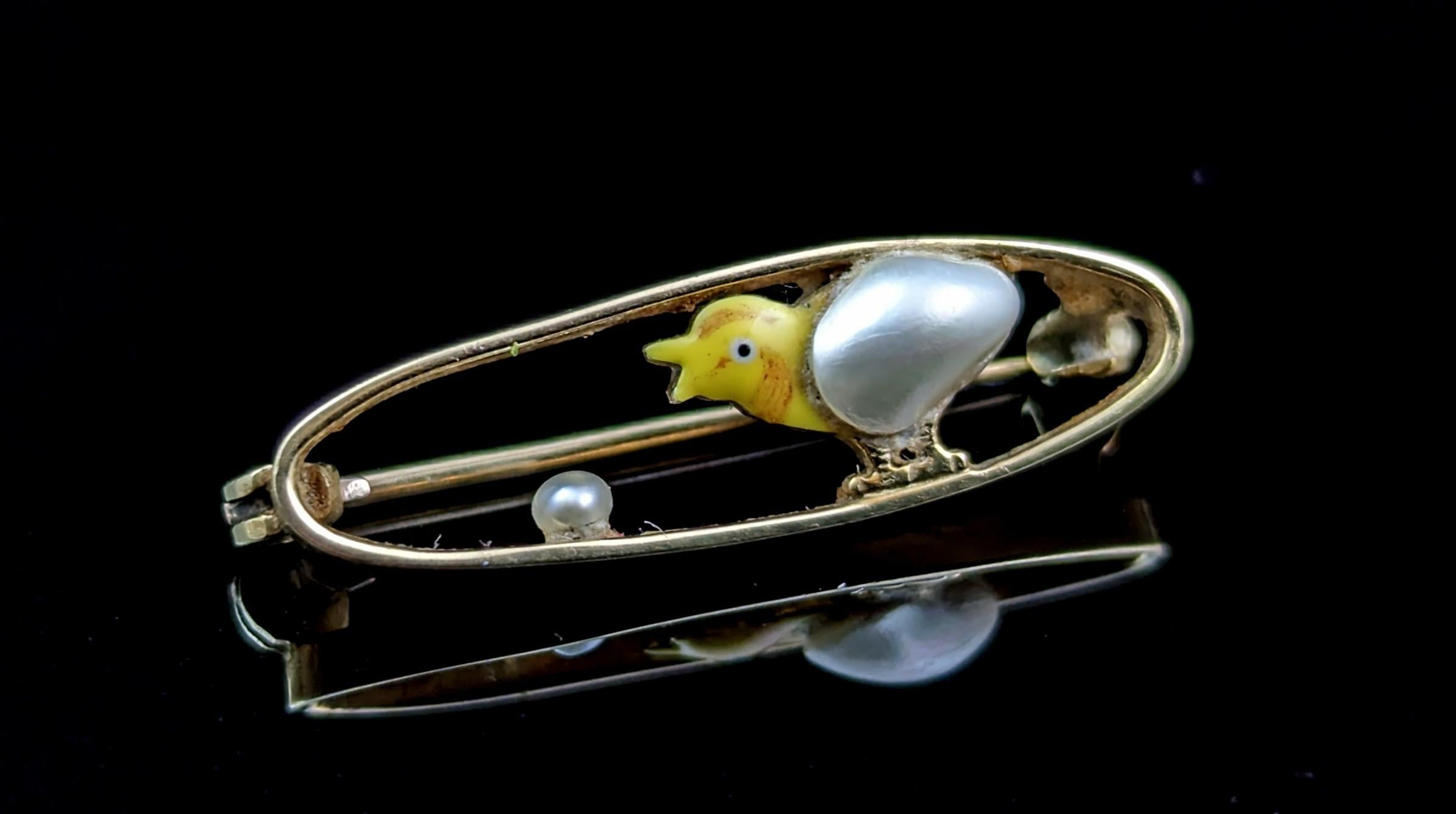 Isn't this dainty antique 15kt gold chick brooch just the sweetest thing?

A teeny little open gold oval in 15kt yellow gold with a tiny little enamelled yellow and baroque pearl baby chick standing within.

There is a small seed pearl as a grain