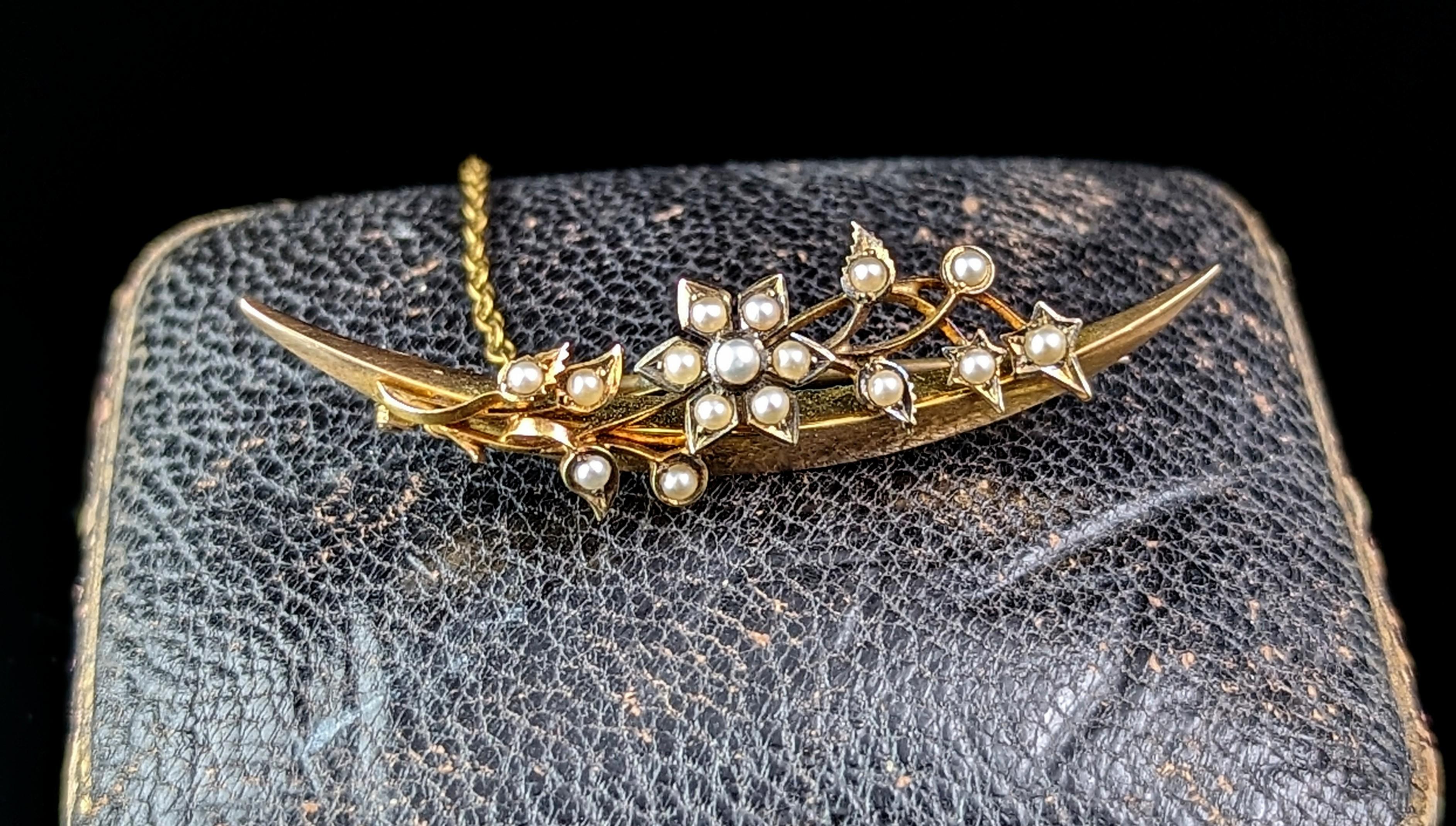 A gorgeous antique, late Victorian Crescent moon and flower brooch.

A beautiful open crescent moon in rich 15ct yellow gold with a pretty spray of flowers over the moon.

The flowers are set with creamy seed pearls.

Crescent moons were a popular