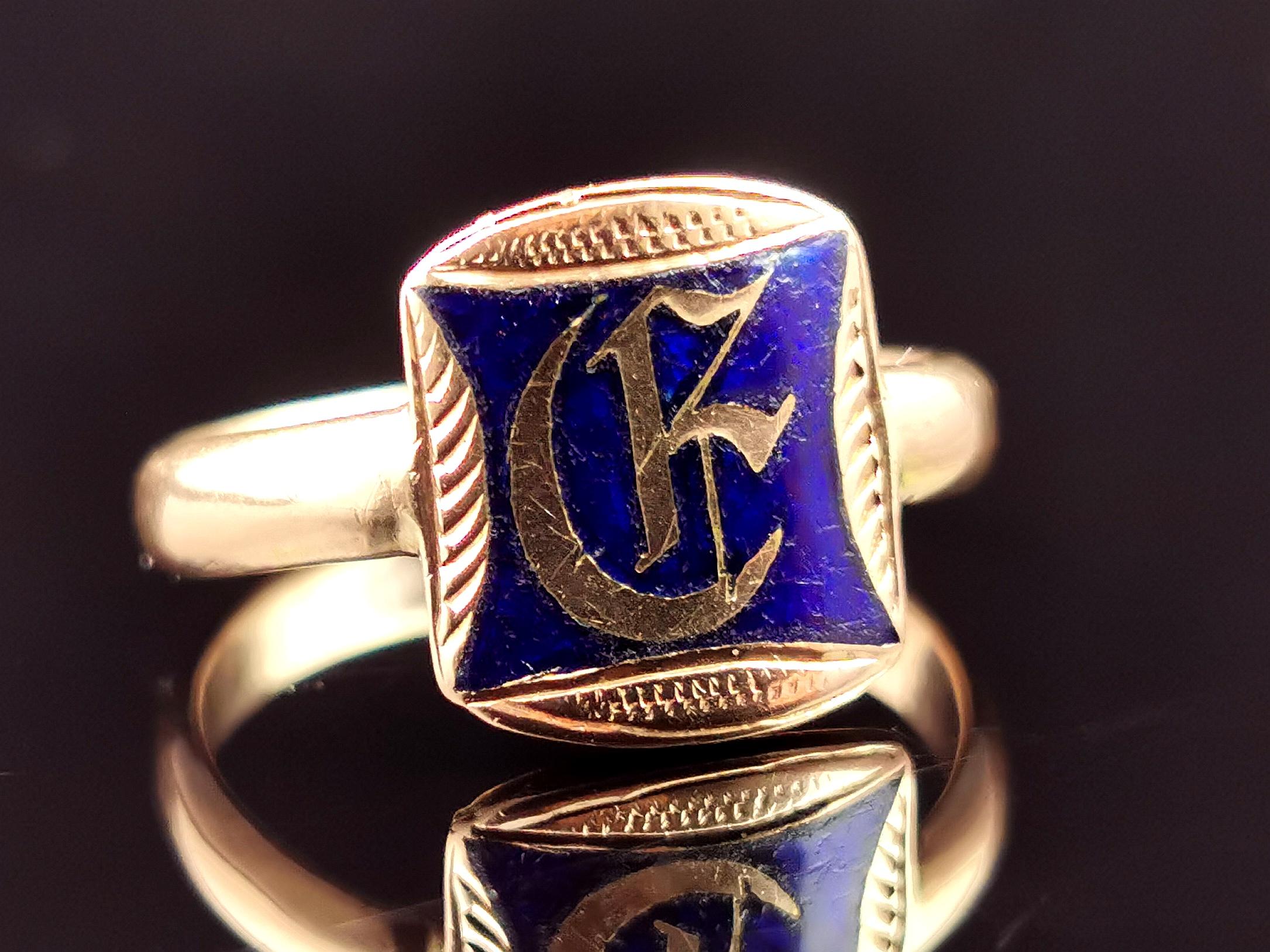 A truly handsome antique 9ct Rose gold monogram signet ring.

It has a rectangular shaped face finished in a royal blue enamel with an engraved monogram of initials in fancy gothic script, each letter has a different style of engraving.

It has a