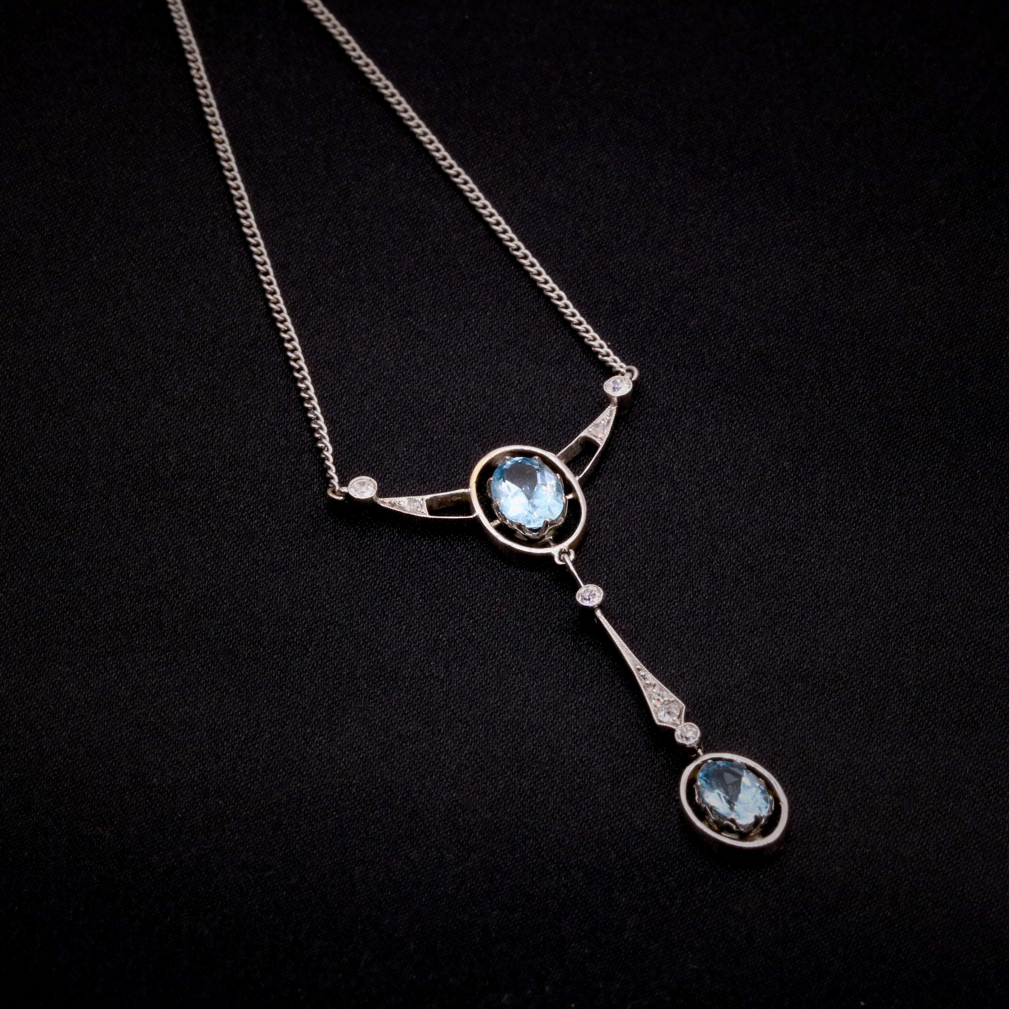 A Belle Epoque aquamarine, diamond, and white gold? necklace, comprising two oval cut aquamarines, three old European cut diamonds, three old single cut diamonds, and two rose cut diamonds, set in 15 karat white gold, with a platinum chain.  

This