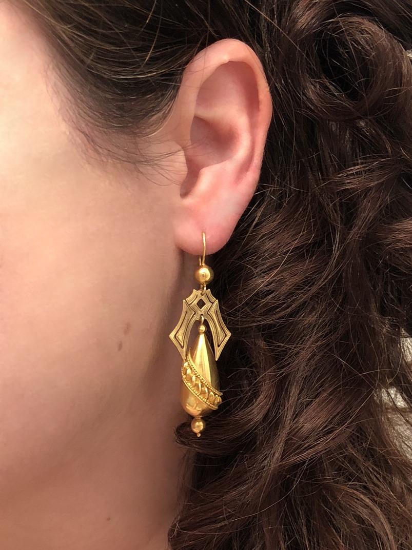 Etruscan Revival 15K yellow gold hollowform drop earrings decorated with granulation and lentil motifs bear maker's marks for Castellani. The earrings measure approxiamtely 2-1/2 inches long and 7/8 inch at the widest point.