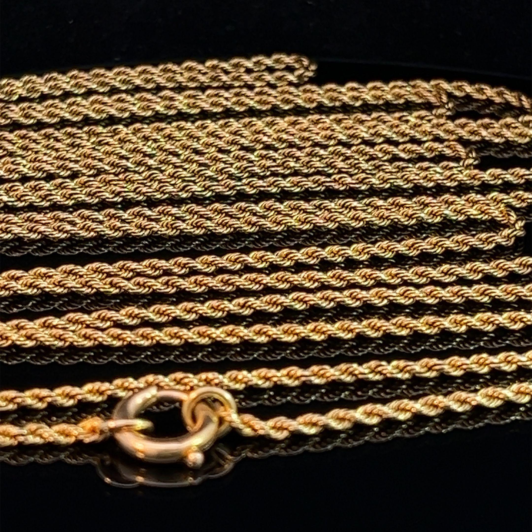 Antique 15k solid yellow gold long guard chain with an intricate twisted rope design. This exquisite chain measures 148cm in length and features a Victorian-style bolt-ring clasp. Its versatile length allows you to wear it as a full-length chain or