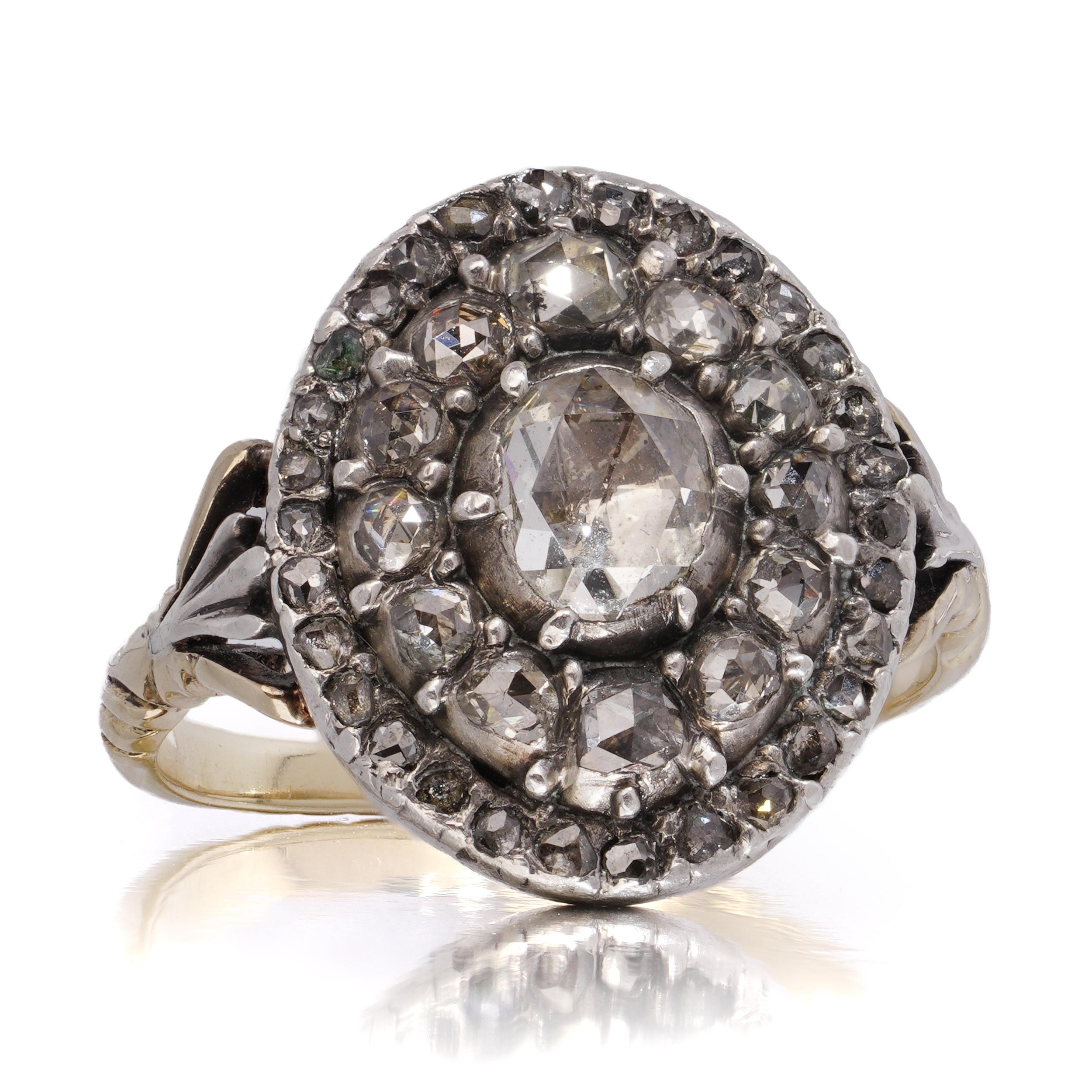 A charming cluster ring crafted in a combination of 15kt yellow gold and silver, showcasing 43 rose-cut diamonds arranged in a concentric circular formation. The diamonds are set in silver over gold.

The central diamond is surrounded by two tiers