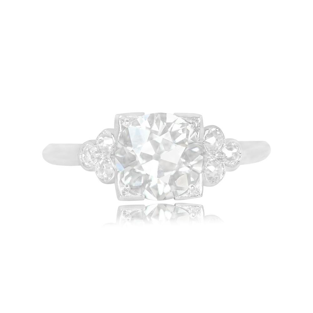 This exquisite Art Deco ring showcases a vibrant 1.65-carat old European cut diamond elegantly set in securely boxed prongs. Adding to its allure, three more old European cut diamonds adorn the sides of the center stone in a captivating geometric