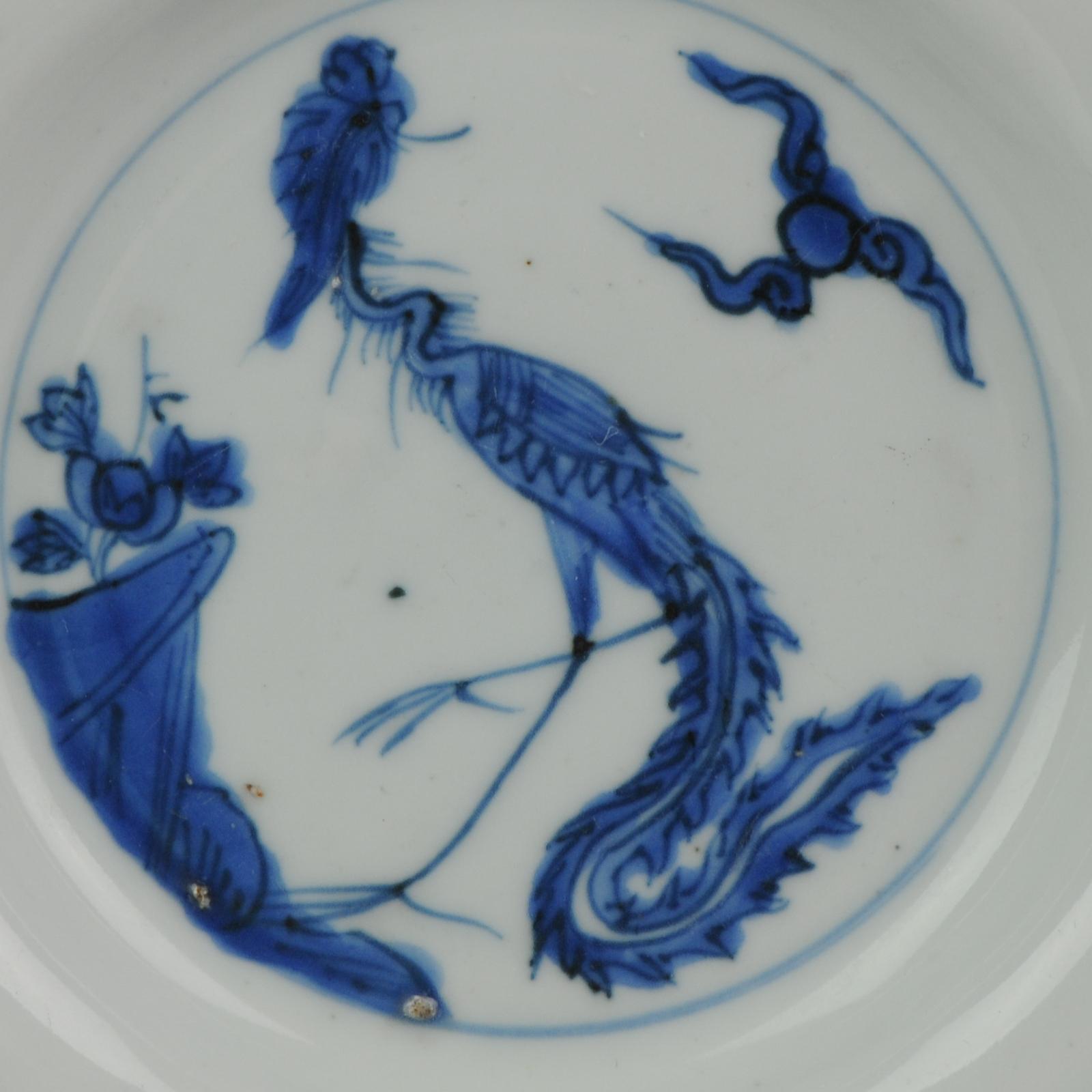 A very nicely decorated Plate, 4th quarter 16th century.

Small dish on footring, wide flat rim. Decorated in underglaze blue with a striding phoenix in schematically rendered landscape with a cloud motif. The sides and rim are undecorated. On the