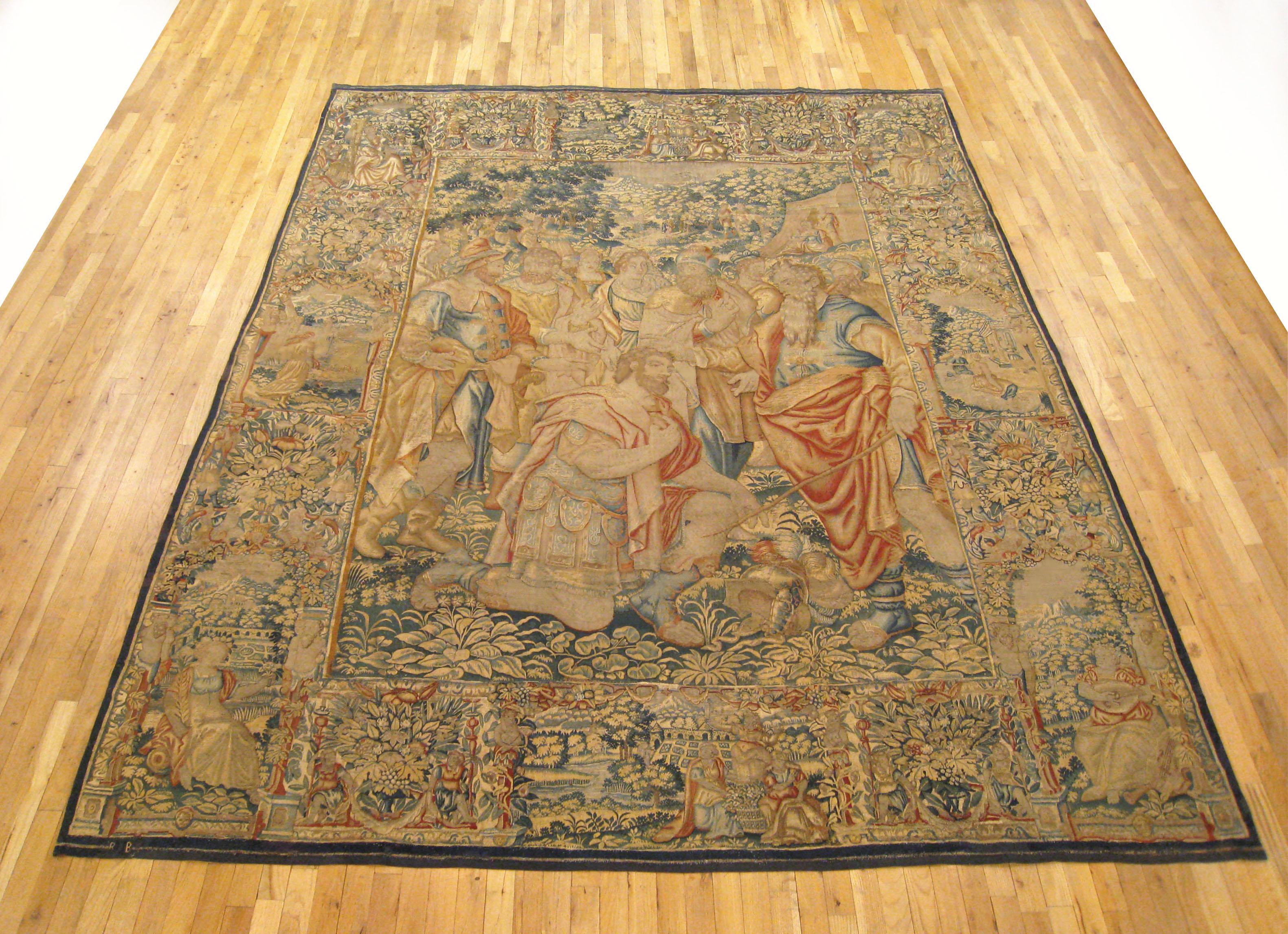 An antique Brussels biblical tapestry from the late 16th century, attributed to Jan (Ian) Raes, depicting Moses at right, with Joshua kneeling before him in the sophisticatedly rendered central field. Enclosed by a wide primary border featuring