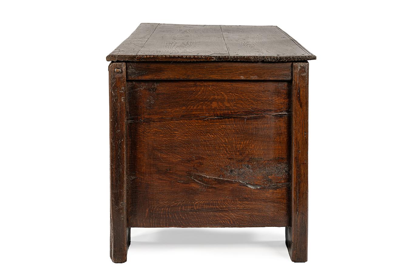 This impressive large Stollentruhe, also known as a Stollentroewe, is a large German storage chest crafted around 1580. Its distinctive construction, with massive upright corner posts—the so-called Stollen—gives the piece its characteristic