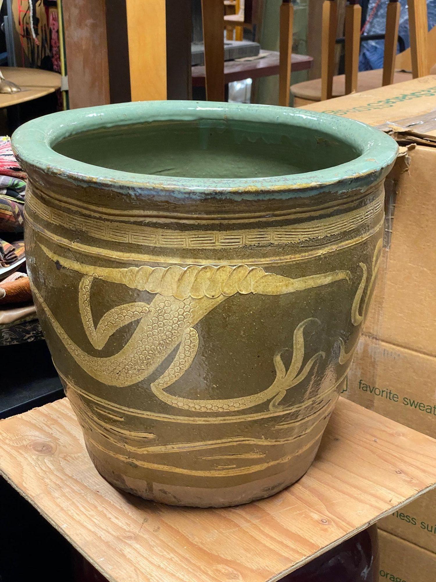 Late 19th Century Century egg Chinese art pottery pot featuring an Asian dragon along the front. These Pots are over 120 years old and were used to store black 