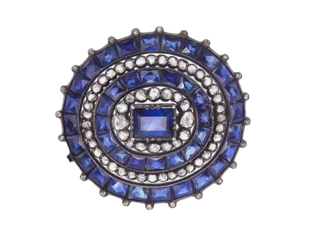 Title:
Antique Sapphire & Diamond Brooch


Gemstone 1:
1.7 Carat Diamond


Number of Stones:
56


Color:
J


Clarity:
SI1


Gemstone 2:
13.9 Carat Saph


Number of Stones:
41


Shape:
Emerald Cut


Gemstone 3:
2.55 Carat Saph


Number of