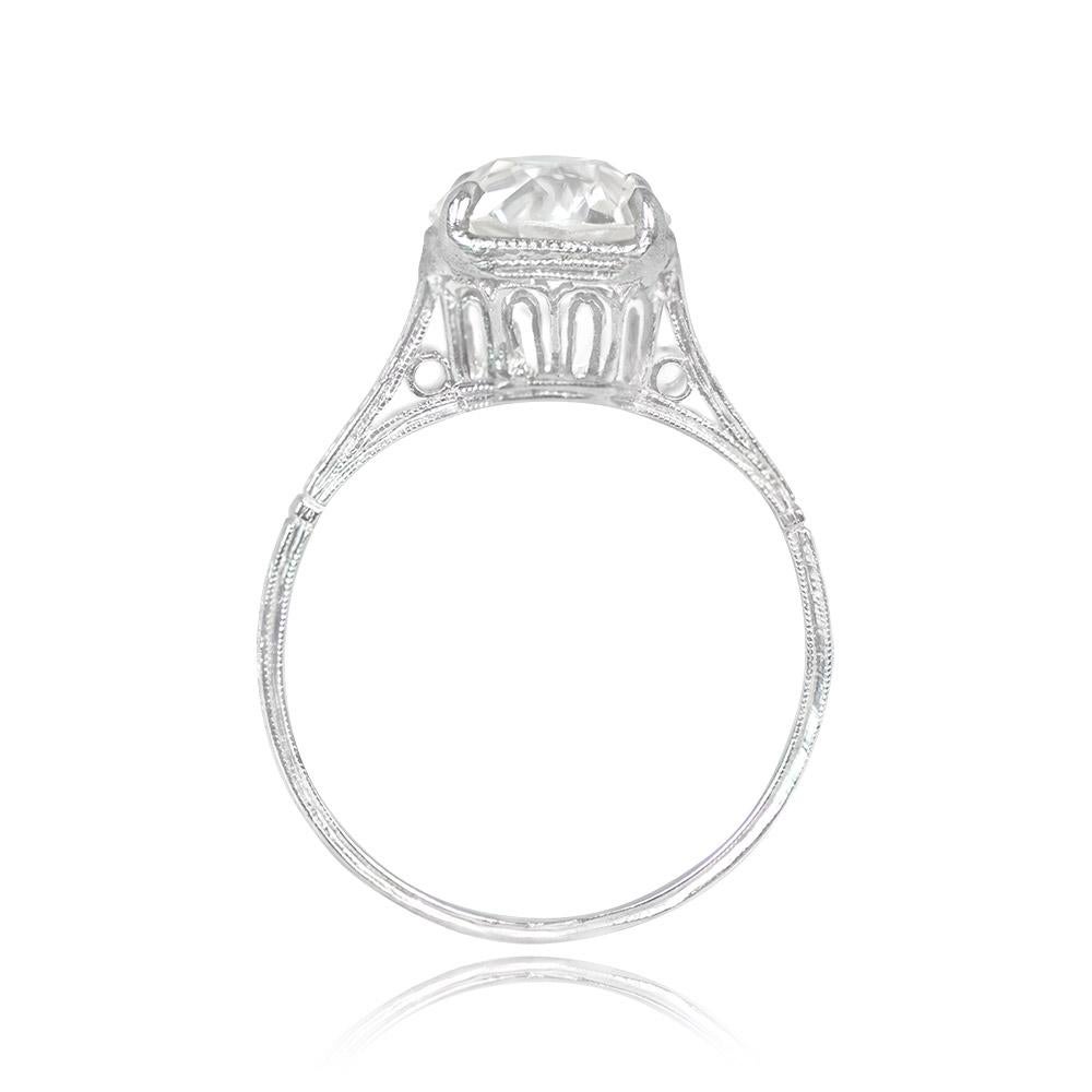 This original Art Deco platinum ring showcases a 1.72-carat old European cut diamond in a prong setting. The diamond, with a J color and SI1 clarity, takes center stage. The ring's shoulders are intricately adorned with openwork cut-outs and