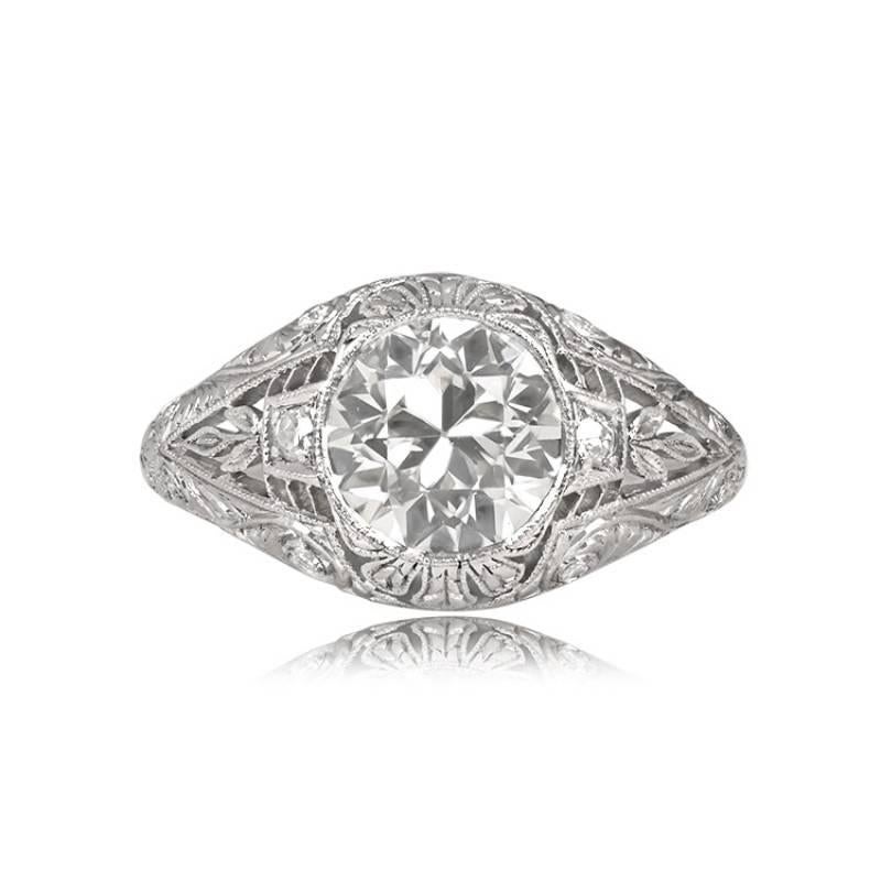This original Art Deco era engagement ring showcases a 1.73-carat, K color, VS1 clarity old European cut diamond, nestled in a bezel setting. The diamond is elegantly presented in a dome-shaped mount adorned with intricate open-work filigree,