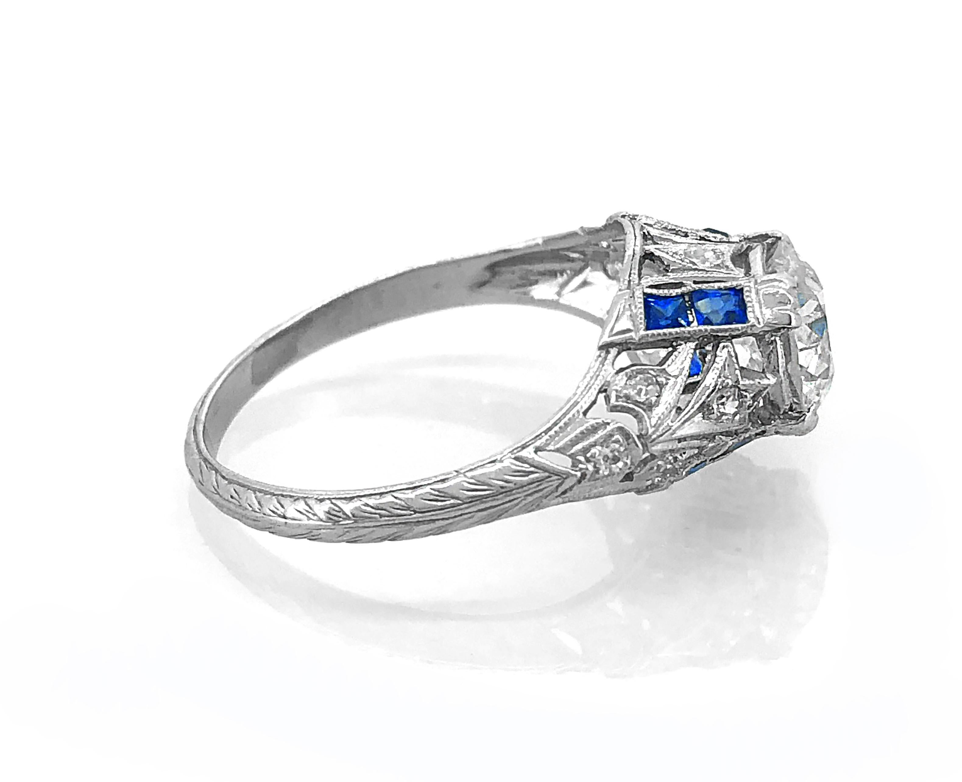 A gorgeous Art Deco diamond & sapphire Antique engagement ring that features a 1.75ct. apx. European cut diamond with SI1 clarity and M color. Accenting the center diamond are .38ct. apx. T.W. of synthetic sapphires (Consistent with the time period)