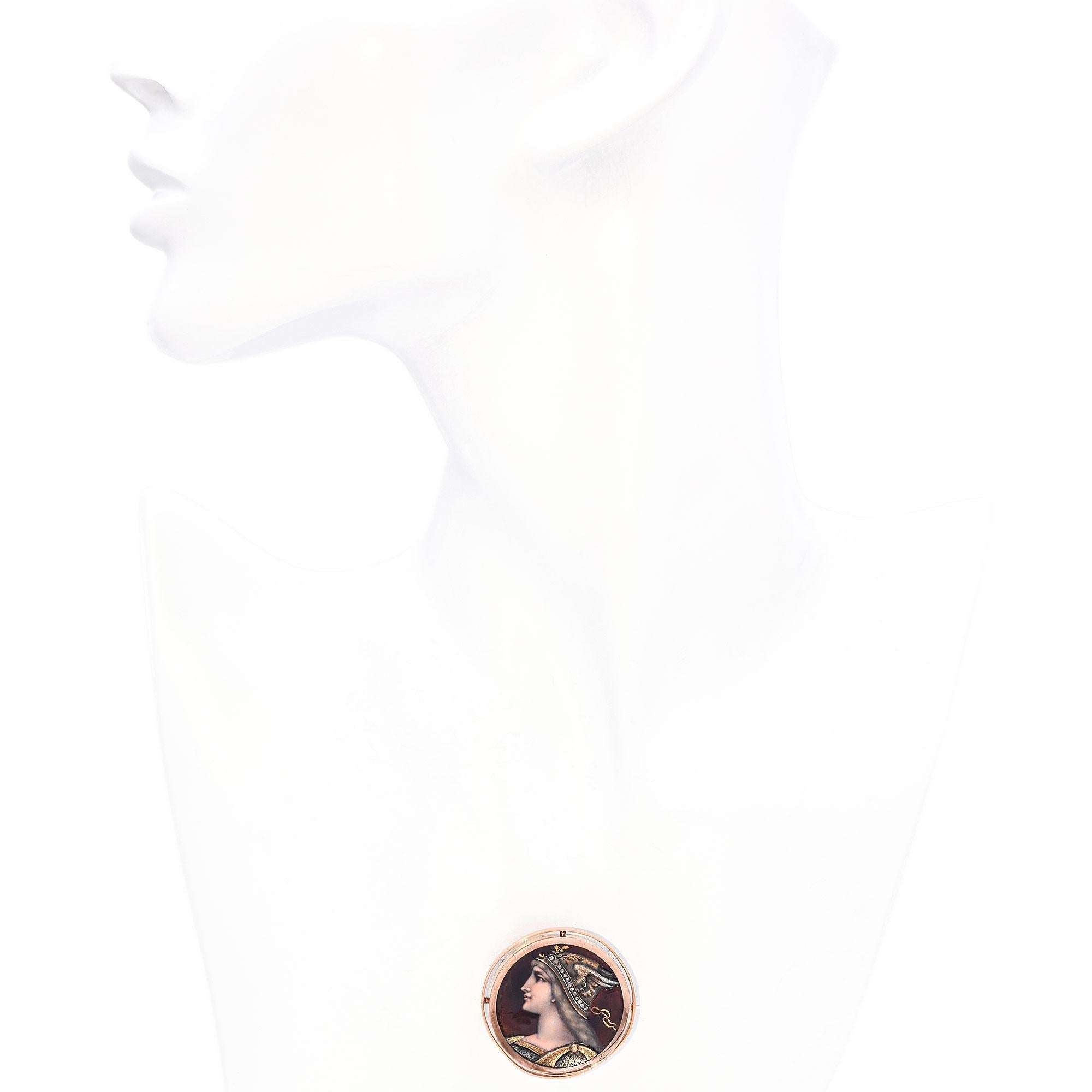This breathtaking 17K rose gold enamel brooch showcases a masterfully hand-painted portrait of Athena, the revered Greek goddess of wisdom and warfare. The stunning enamel work captures Athena’s serene yet powerful expression, complemented by