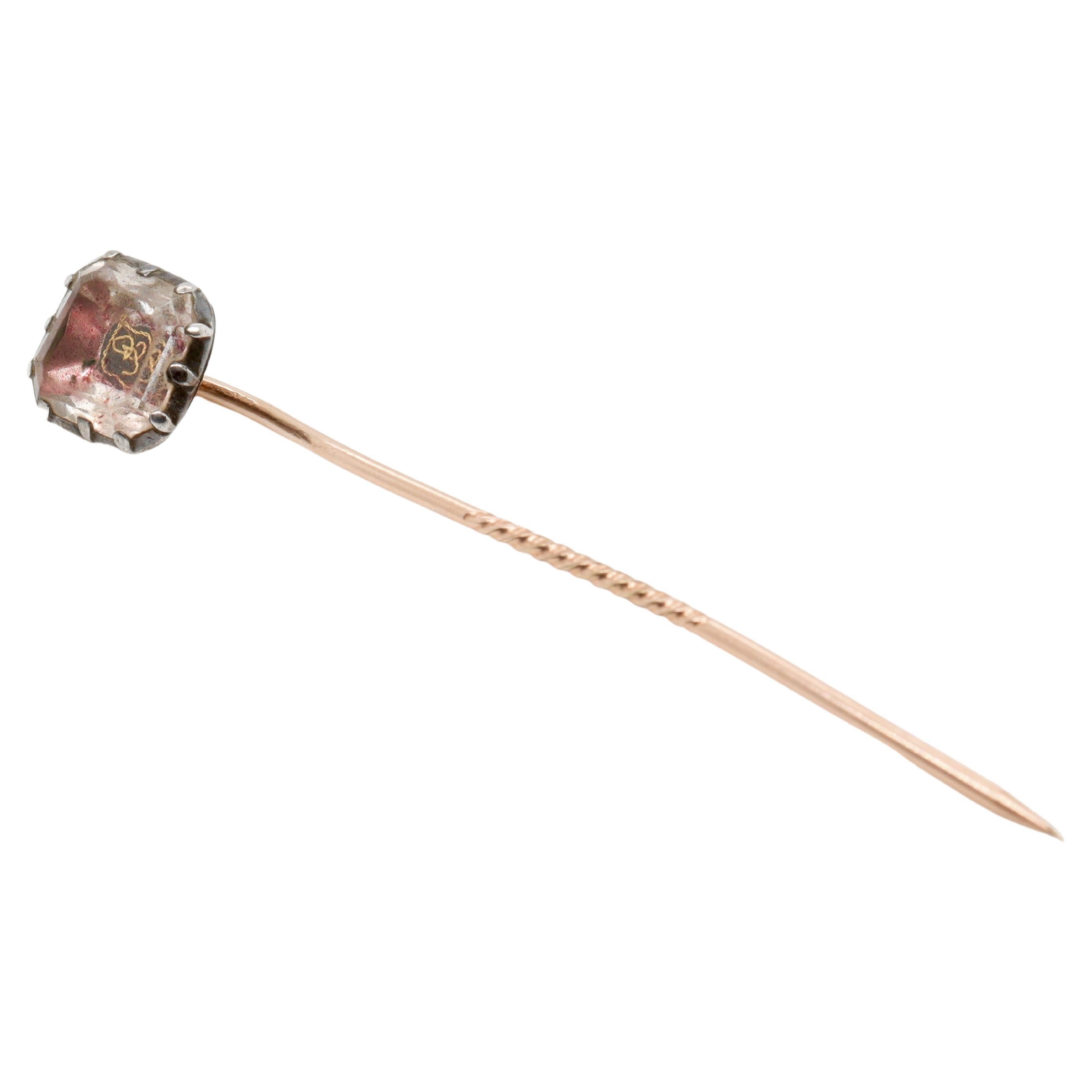 A fine antique Stuart Crystal stick pin.

Set with a faceted rock crystal, traces of pink and red foil, and a gold wire cypher.

The pin is likely adapted from an early 17th or 18th Century button. Stuart Crystals memorialized the slain King Charles