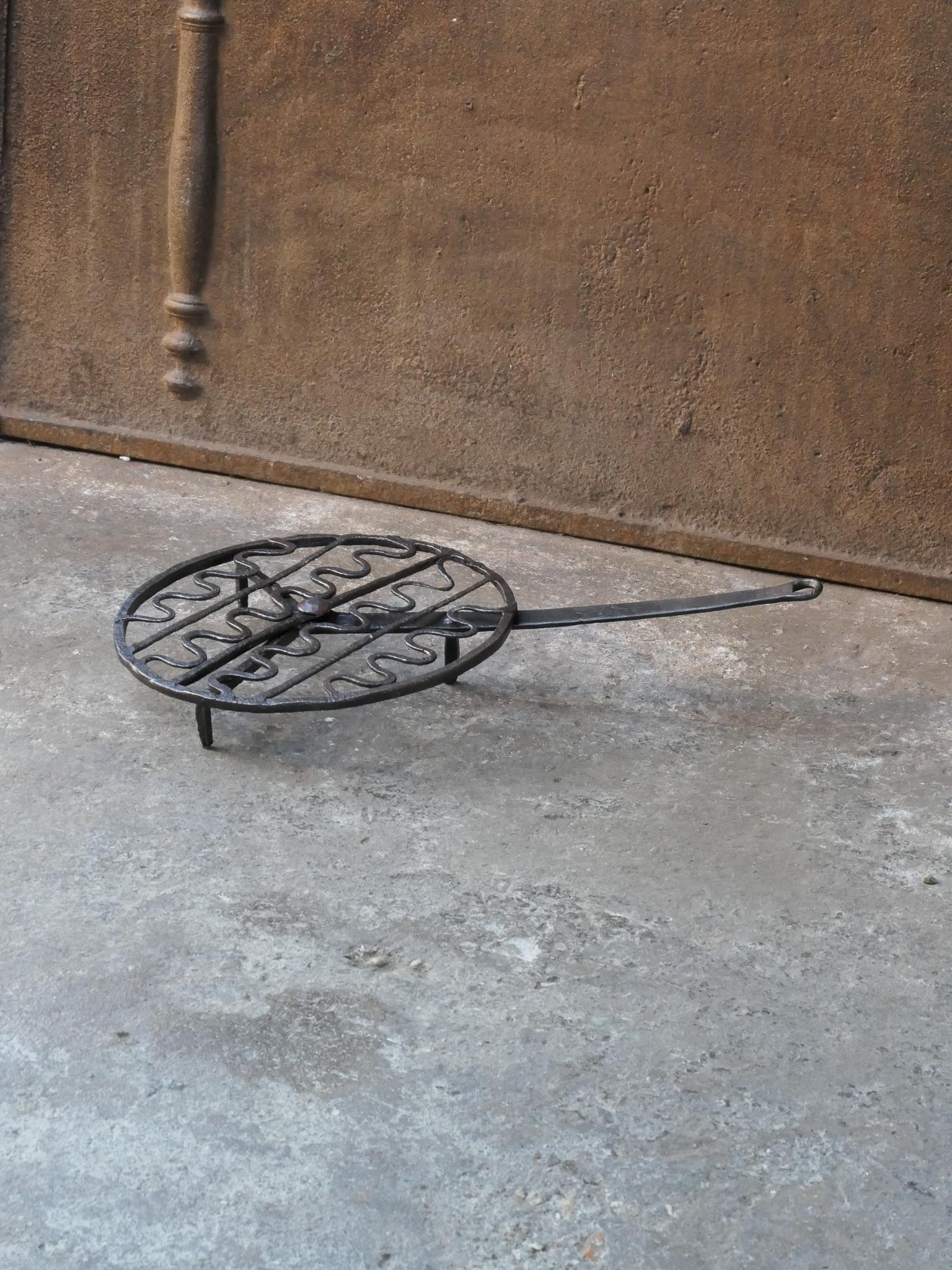 17th - 18th Century French rotating gridiron made of wrought iron. It was used to prepare small pieces of meat quickly over the fire. Sometimes they were put in the fire or else on a trivet, depending on the size of the fire. The gridiron is in a