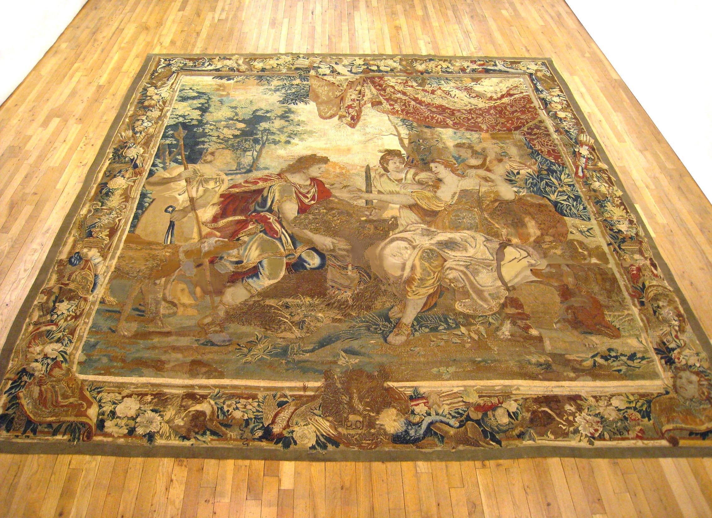 An antique 17th century Brussels mythological tapestry, size 11'6 H x 10'8 W, from the workshop of the renowned weaver, Jan Leyniers, after cartoons by Charles Le Brun and François Bellin for the landscapes. The set was rewoven many times with some